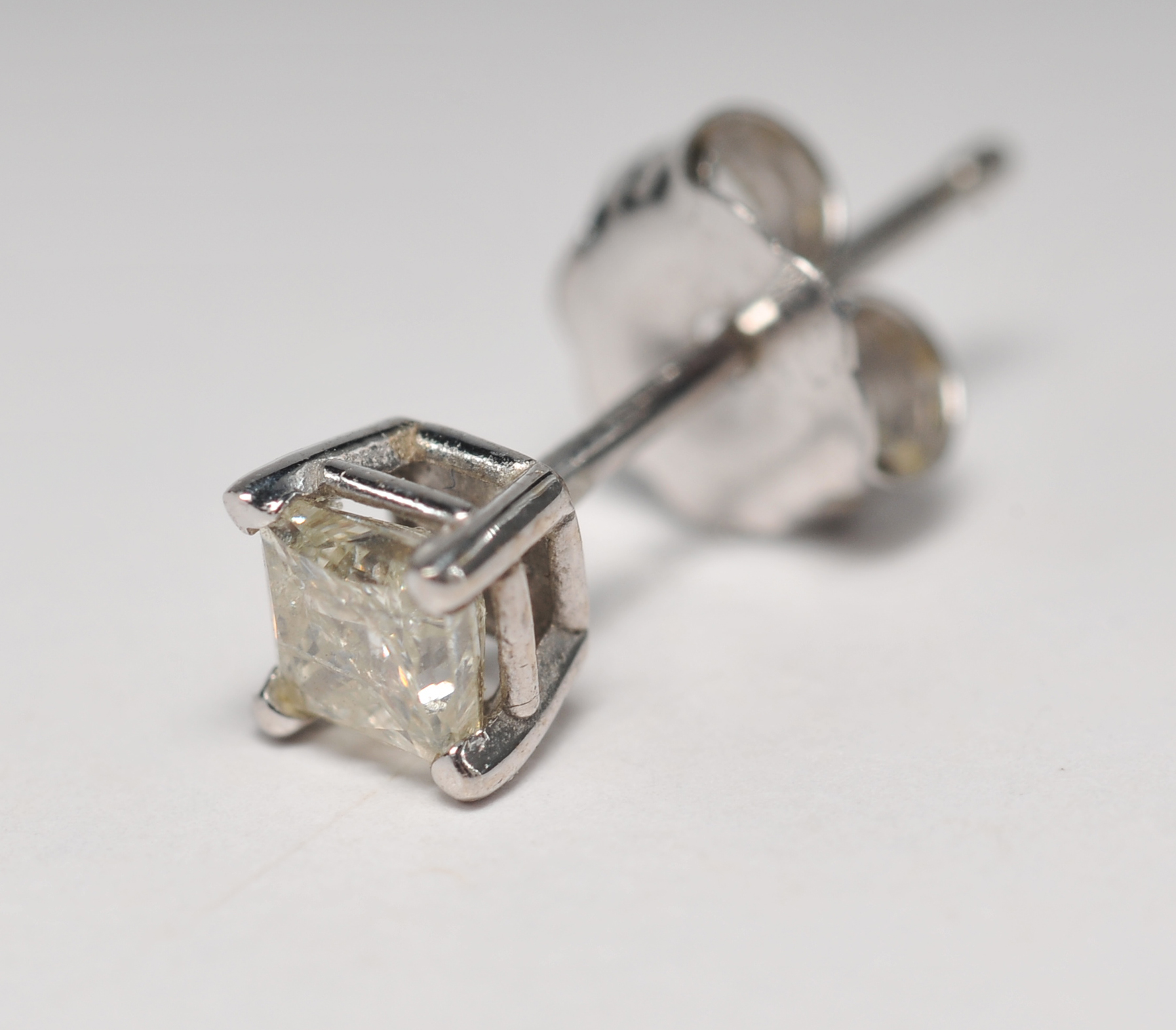 Pair of 14 K white gold and square cut diamond stud earrings 