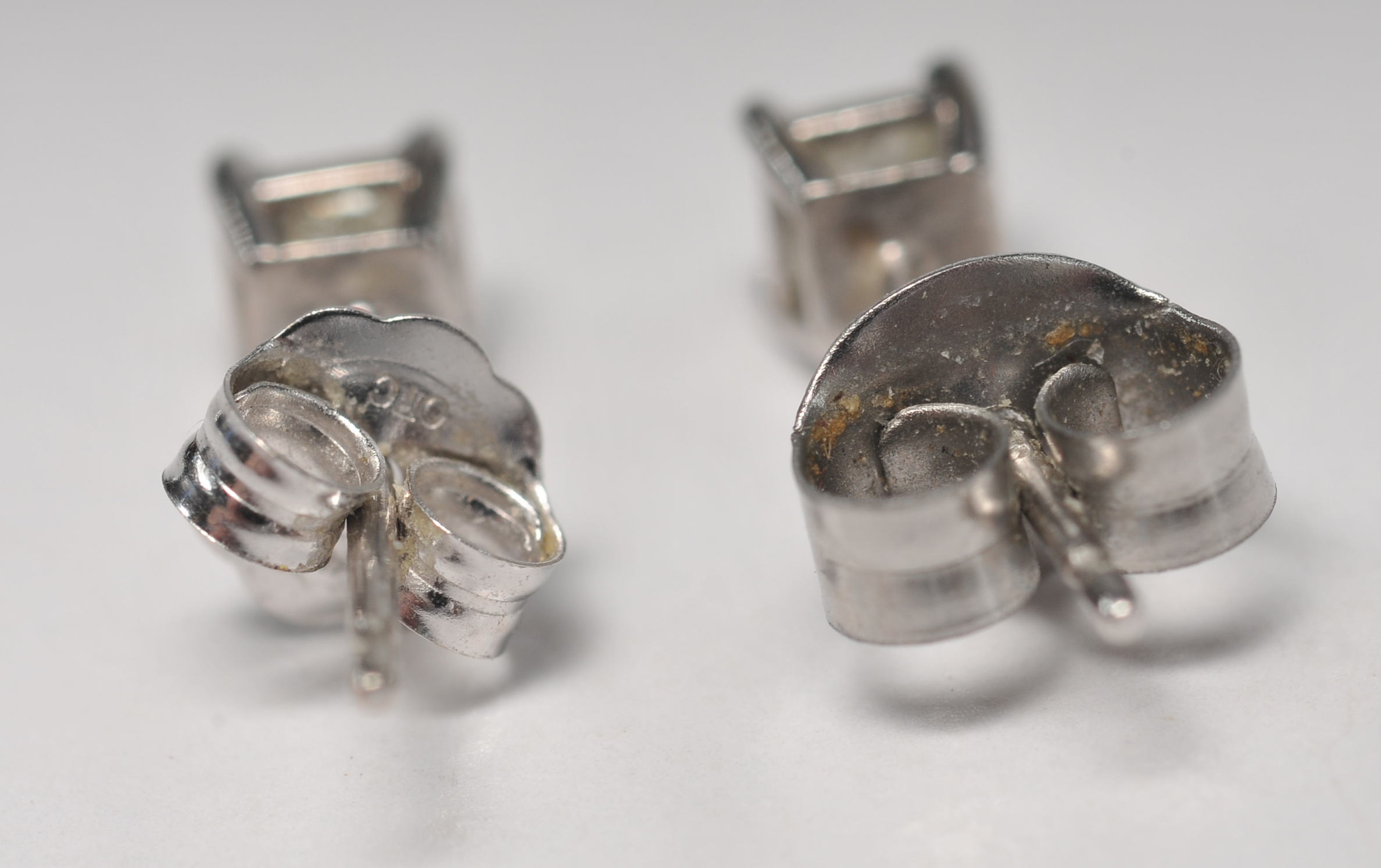 Pair of 14 K white gold and square cut diamond stud earrings 