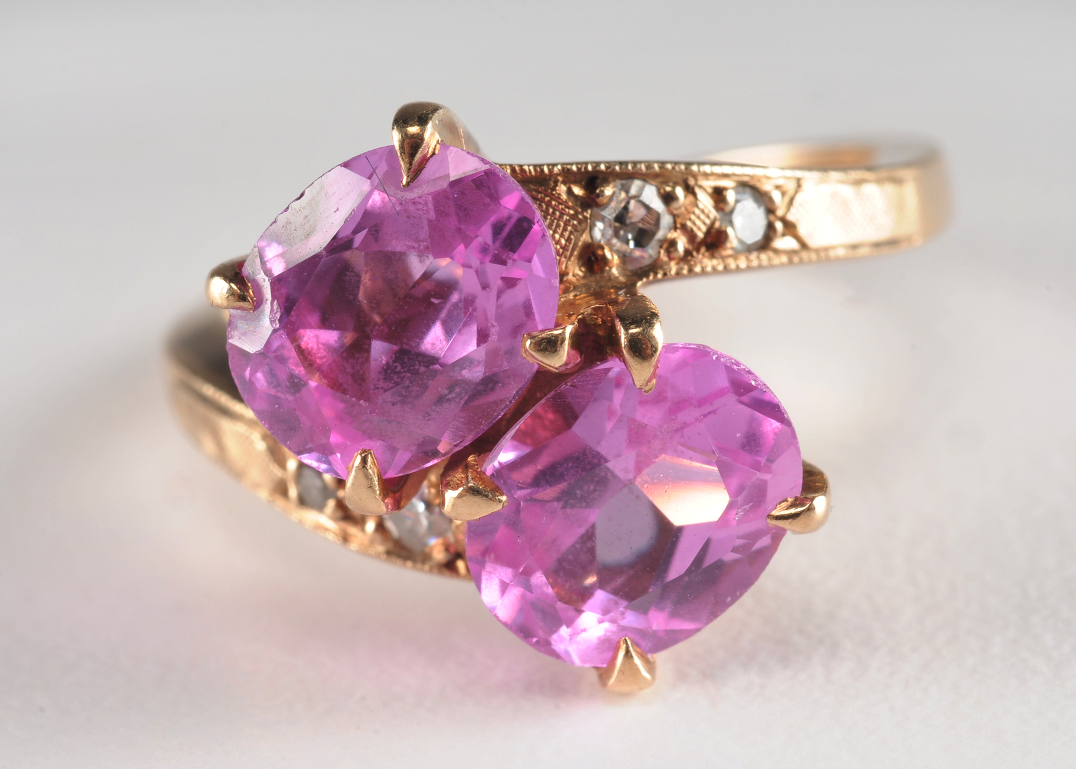 Ladies 14 K yellow gold ring with synthetic pink sapphires and diamonds