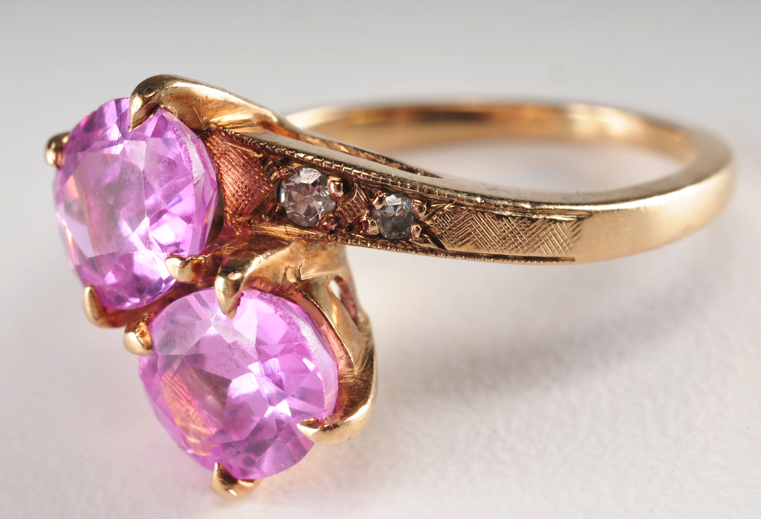 Ladies 14 K yellow gold ring with synthetic pink sapphires and diamonds