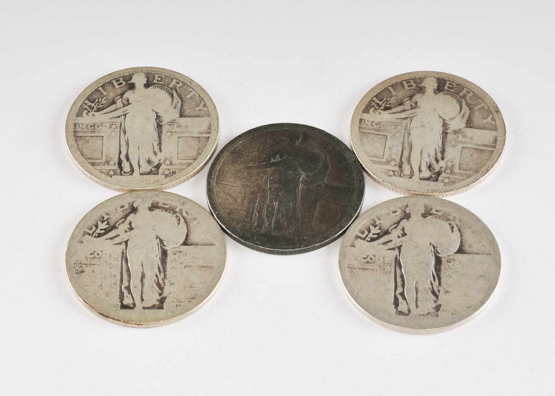Group of (5) silver Standing Liberty quarters with unreadable dates
