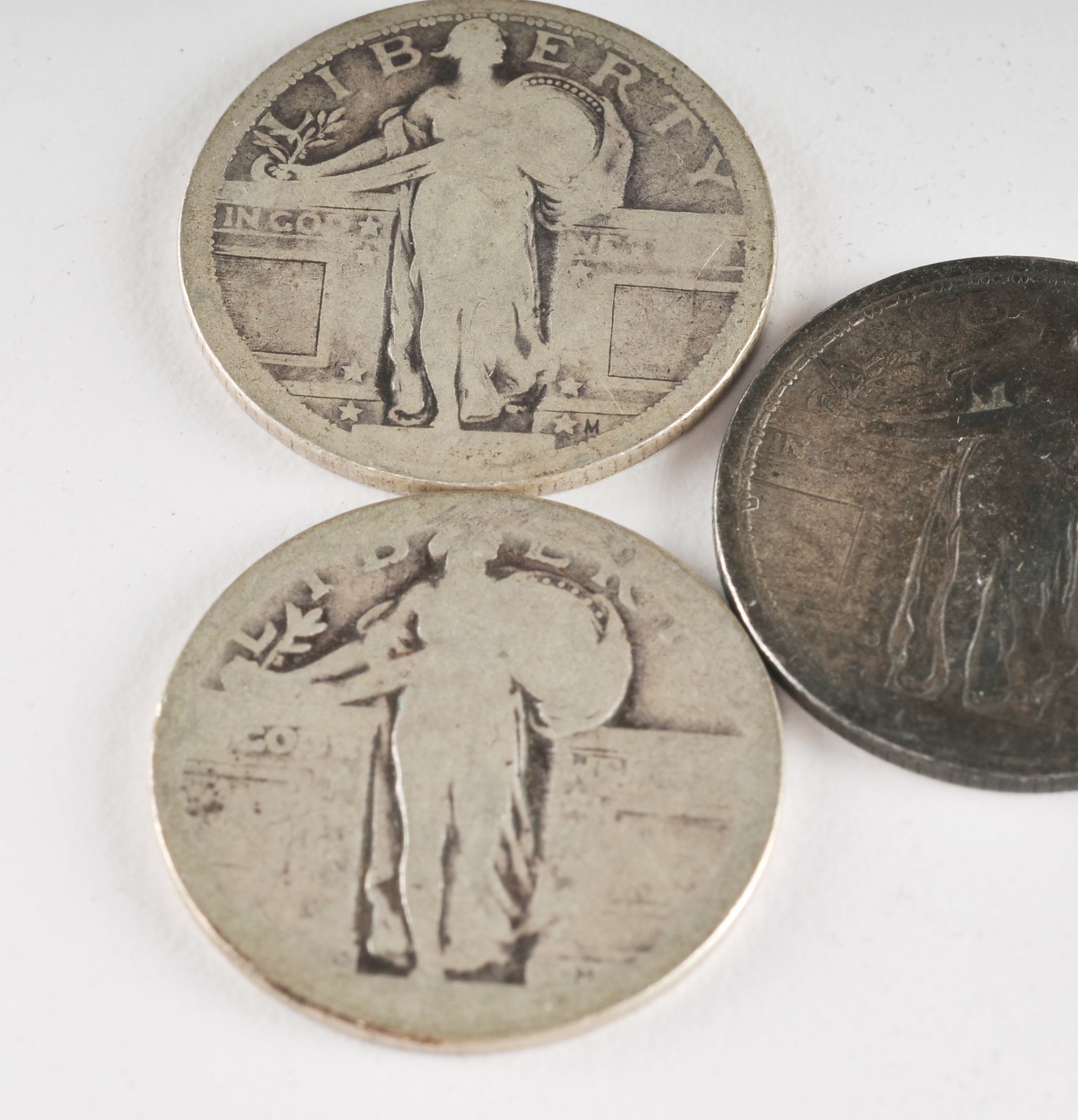 Group of (5) silver Standing Liberty quarters with unreadable dates