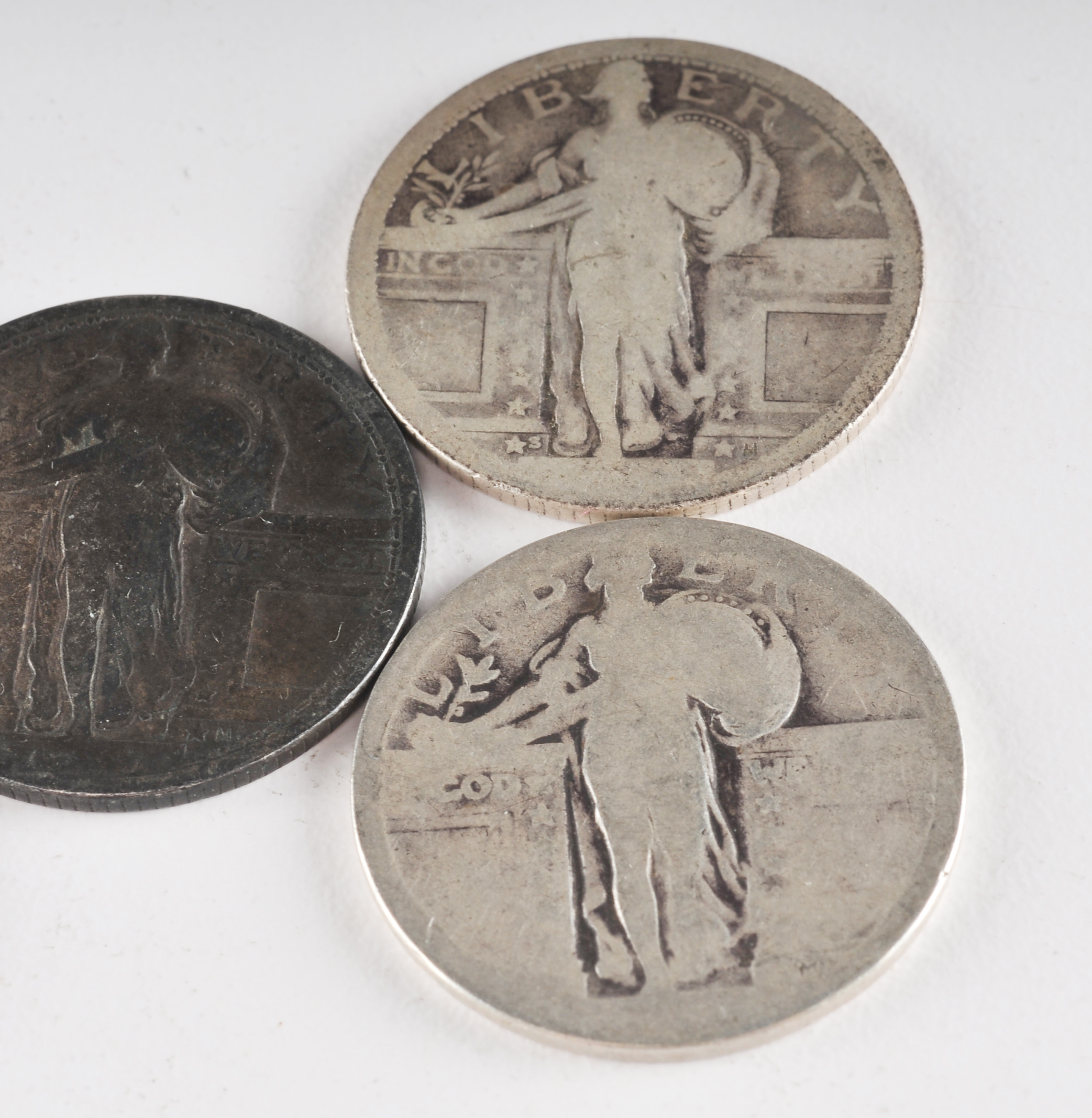 Group of (5) silver Standing Liberty quarters with unreadable dates