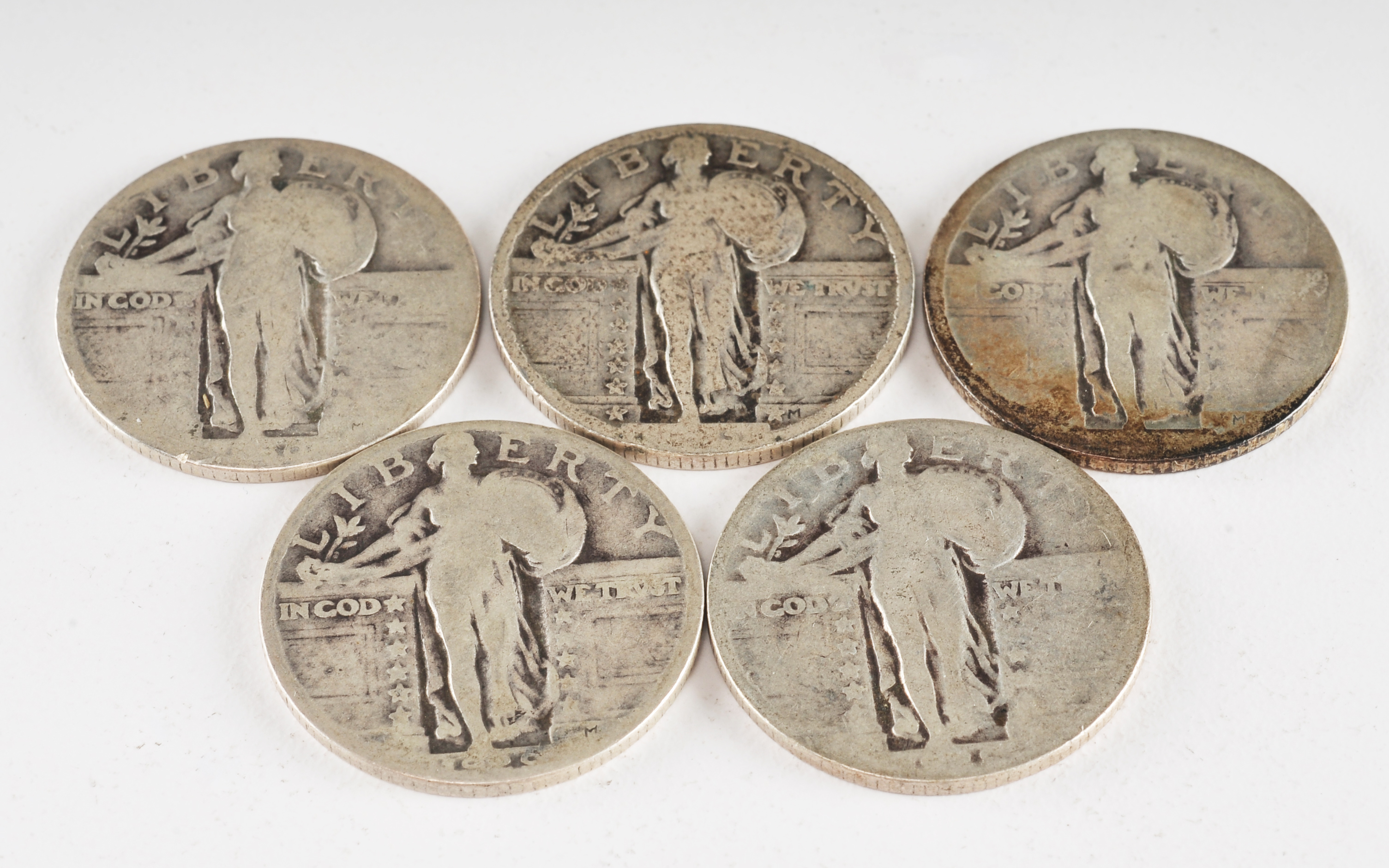Group of (5) silver Standing Liberty quarters with unreadable dates