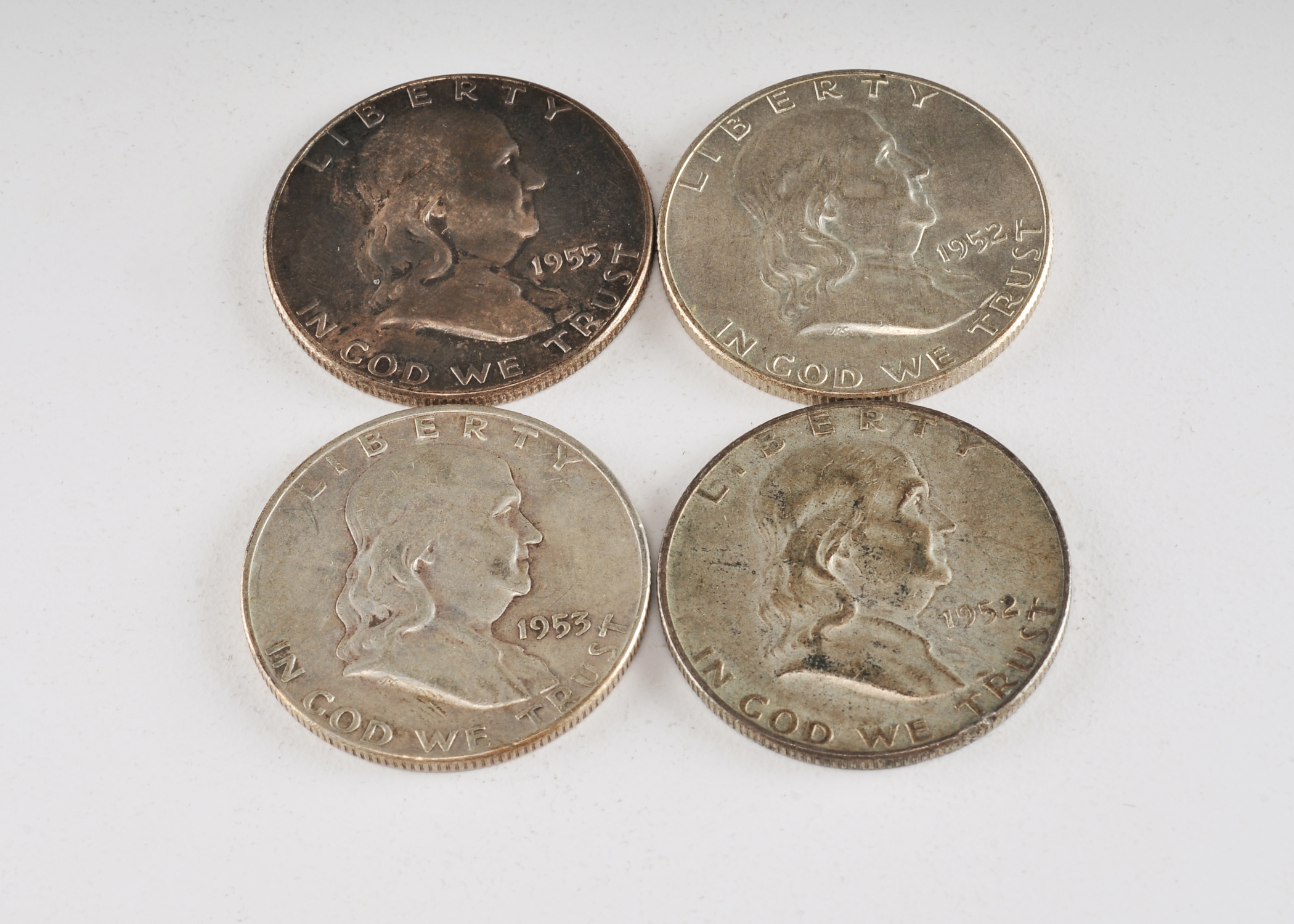 Group of (4) Franklin silver half dollars including the following: (2) 1952 D, (1) 1953 D, and (1) 1955