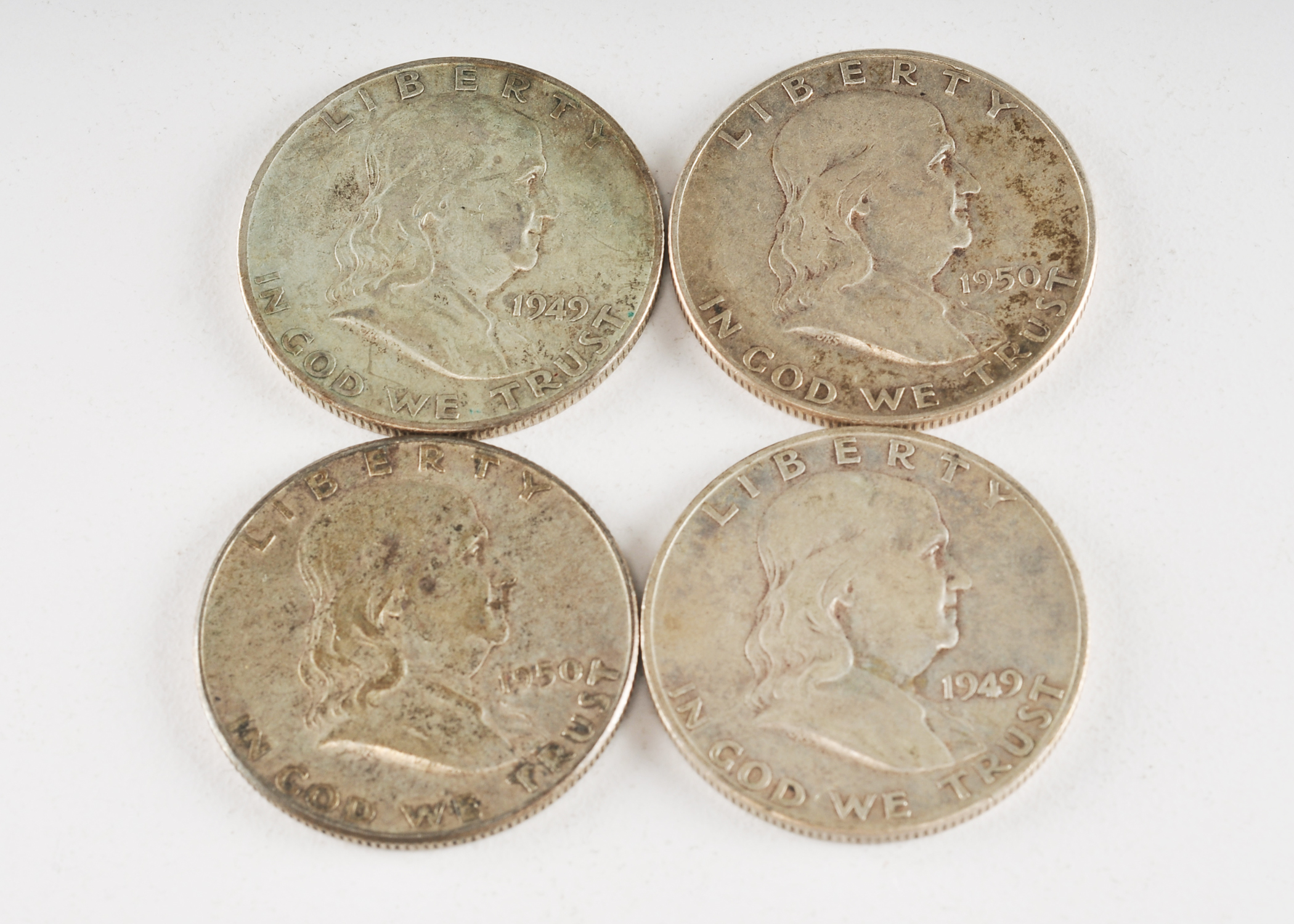 Group of (4) Franklin silver half dollars including the following: (2) 1949 S, and (2) 1950