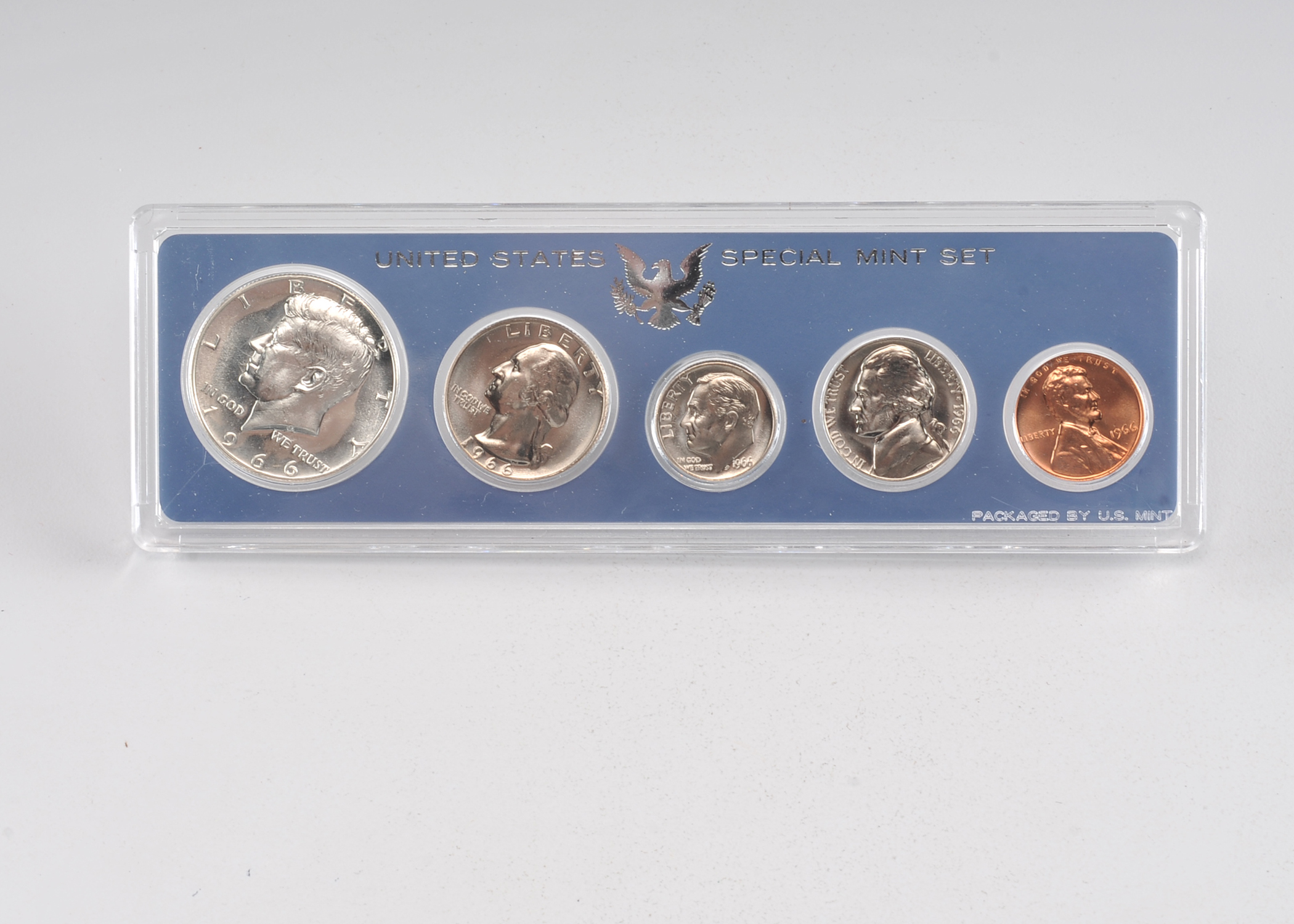 1966 United States special mint set including a JFK half dollar, Washington quarter, Roosevelt dime, Jefferson nickel, and Lincoln penny