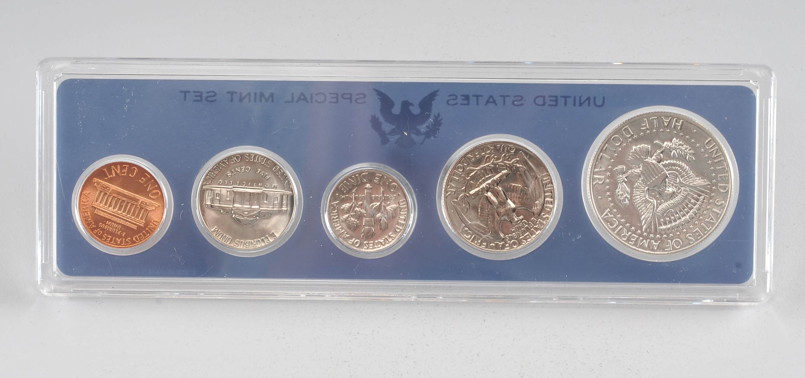 1966 United States special mint set including a JFK half dollar, Washington quarter, Roosevelt dime, Jefferson nickel, and Lincoln penny