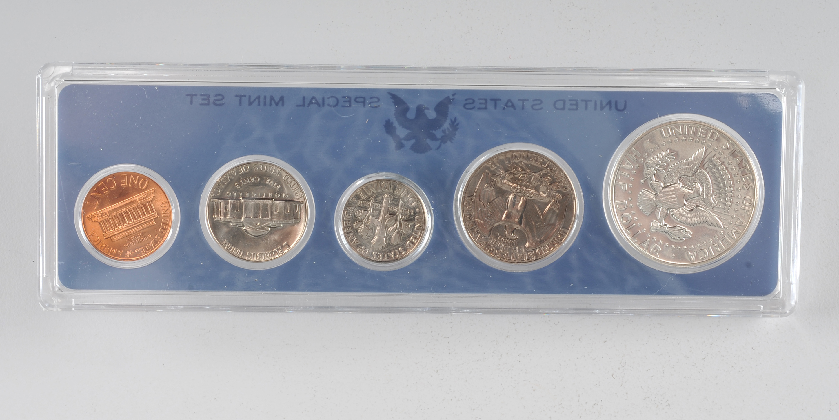 1966 United States special mint set including a JFK half dollar, Washington quarter, Roosevelt dime, Jefferson nickel, and Lincoln penny