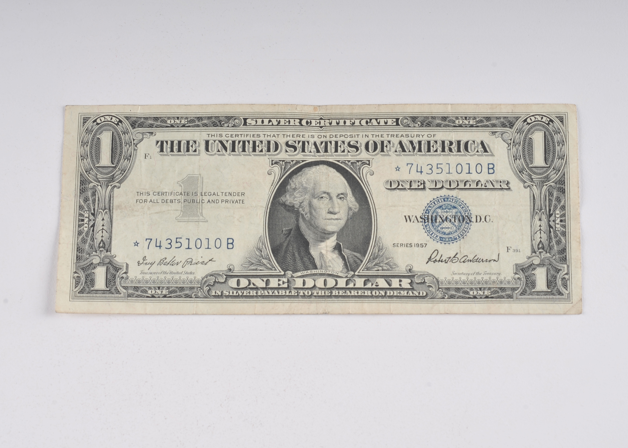 1957 One Dollar silver certificate with blue seal with star in the serial number