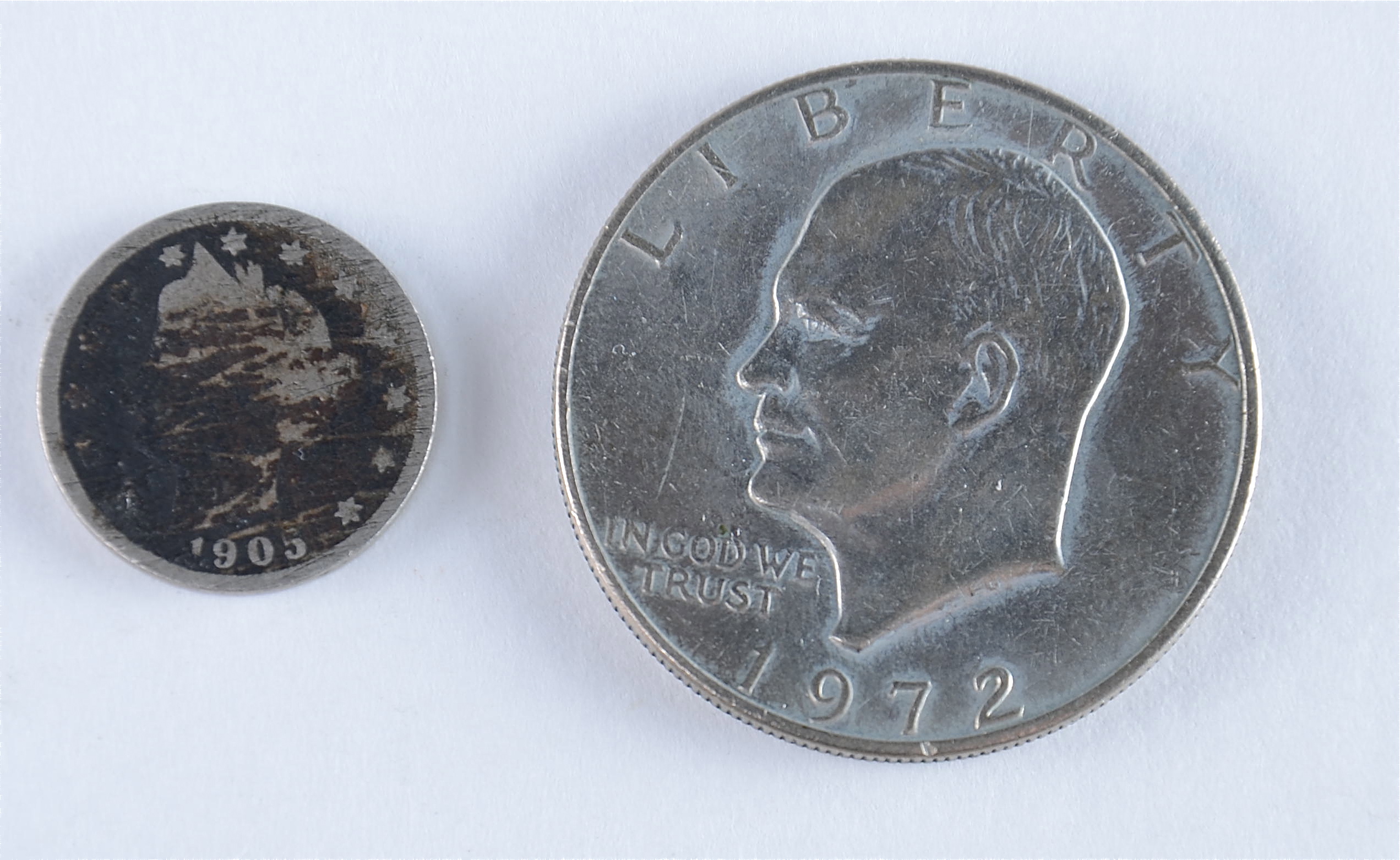 Group of American coins including the following: 1937 and 1944 wheat pennies, 1905 and 1911 Liberty nickels, 1976 Roosevelt dime, and a 1972 Eisenhower dollar1938 S, 1939, 1939 D, and 1939 S