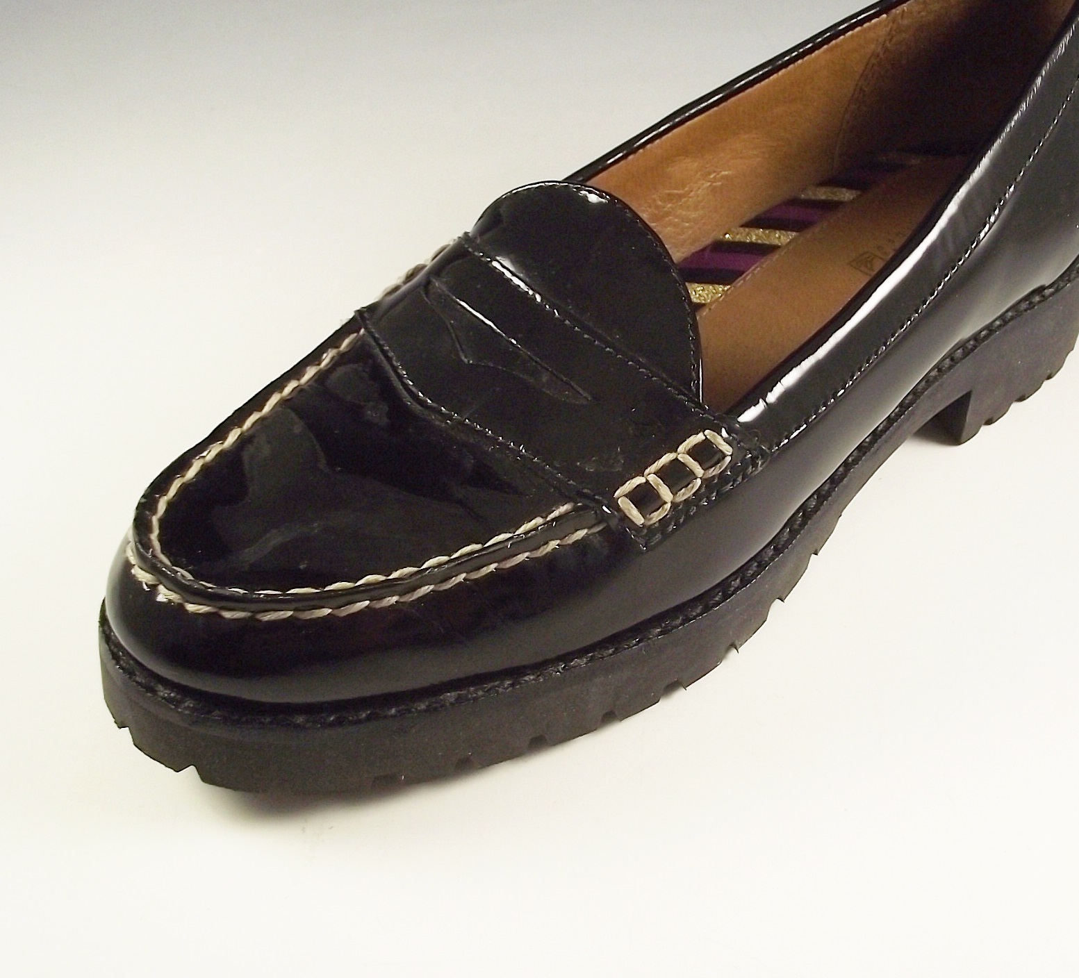 Sperry Top Sider black patent leather penny loafers.