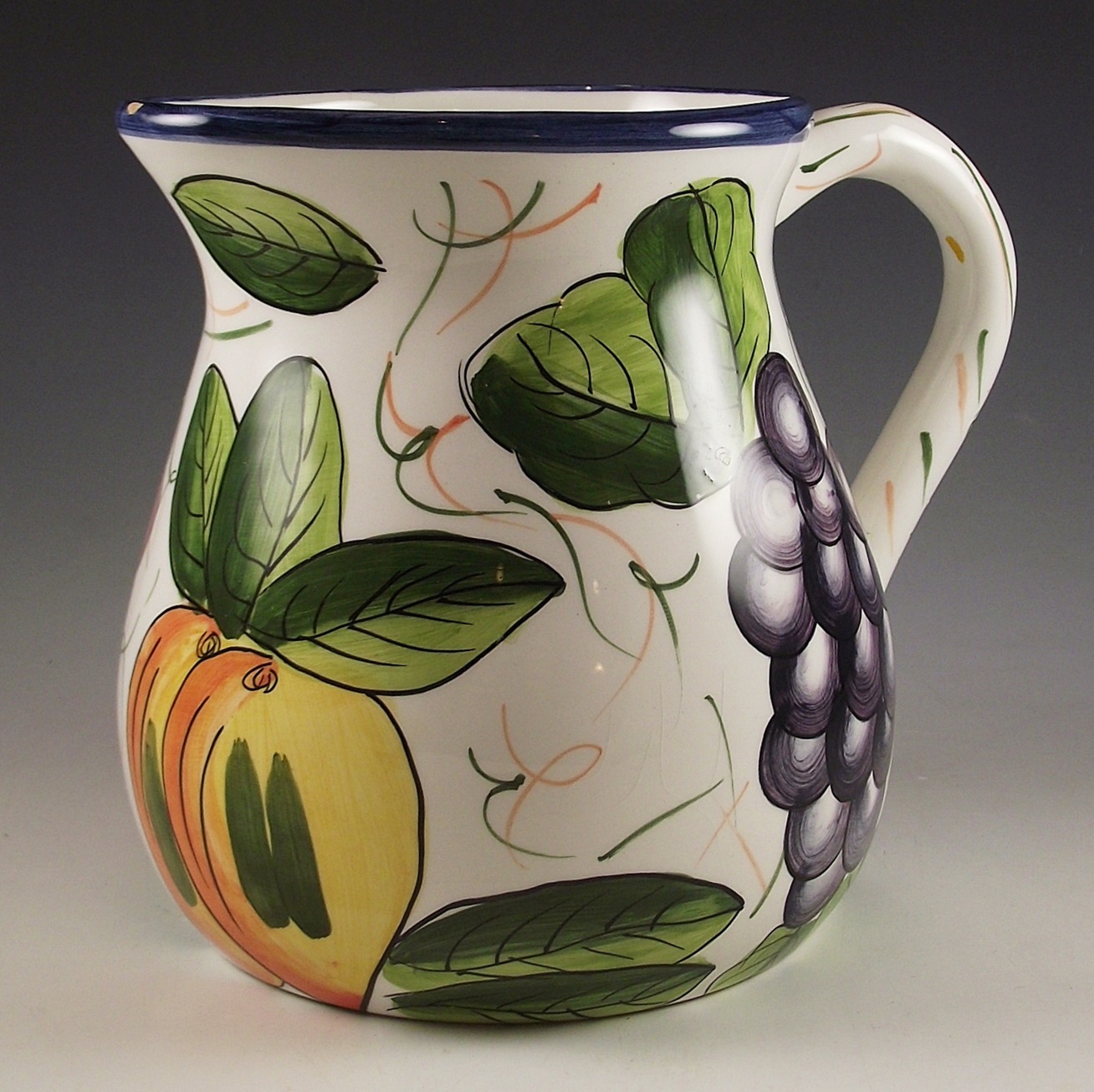 Three ceramic pitchers with painted designs.