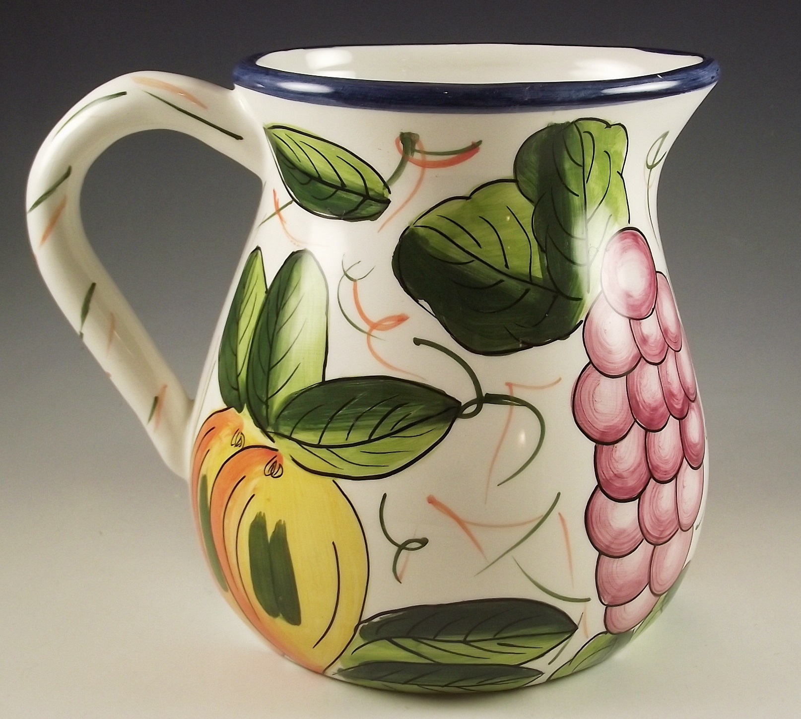 Three ceramic pitchers with painted designs.