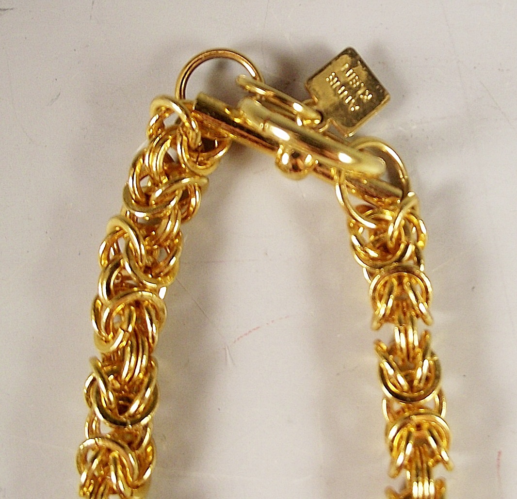 Four gold tone necklaces.