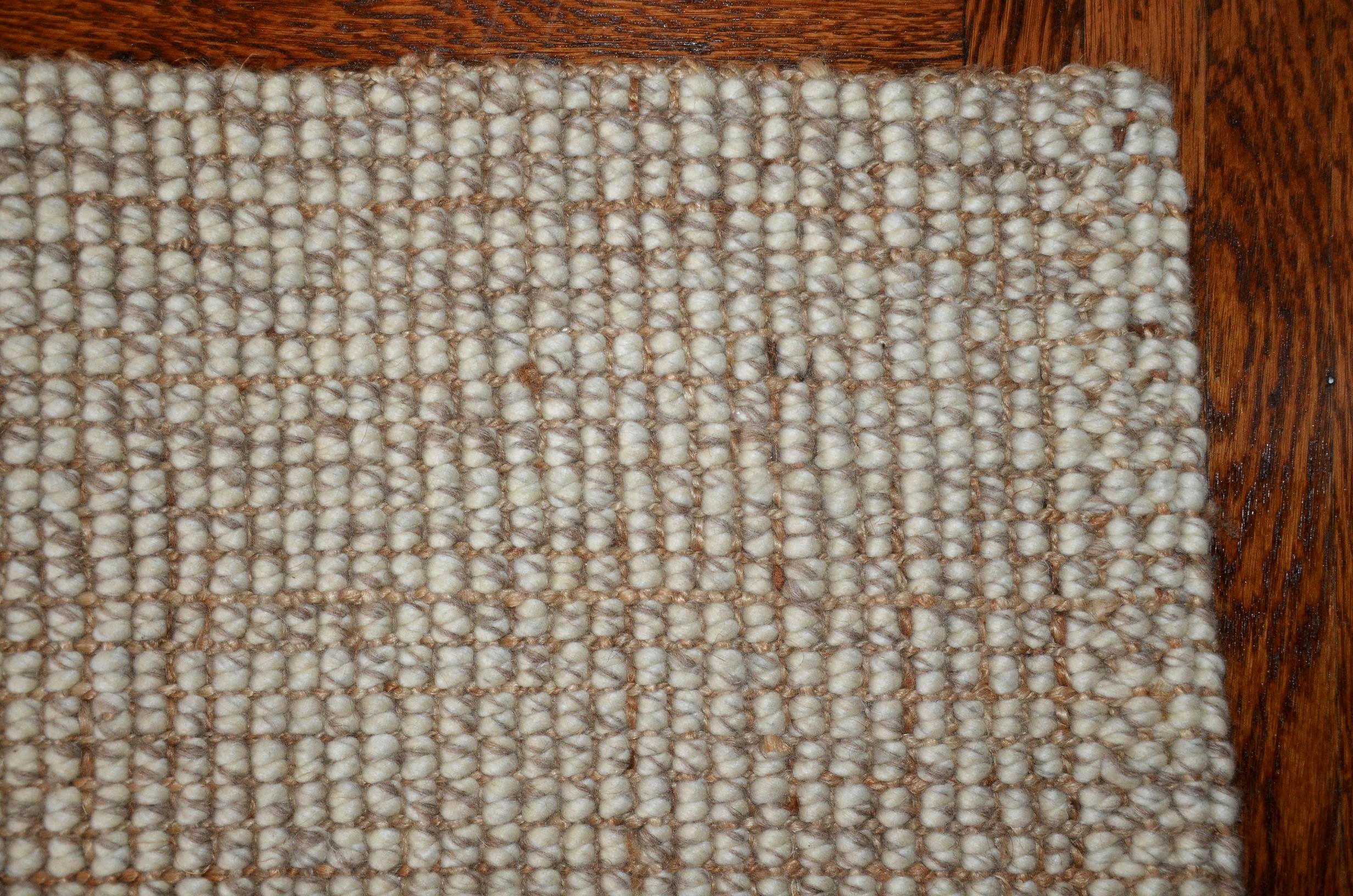 Neutral wool area rug.