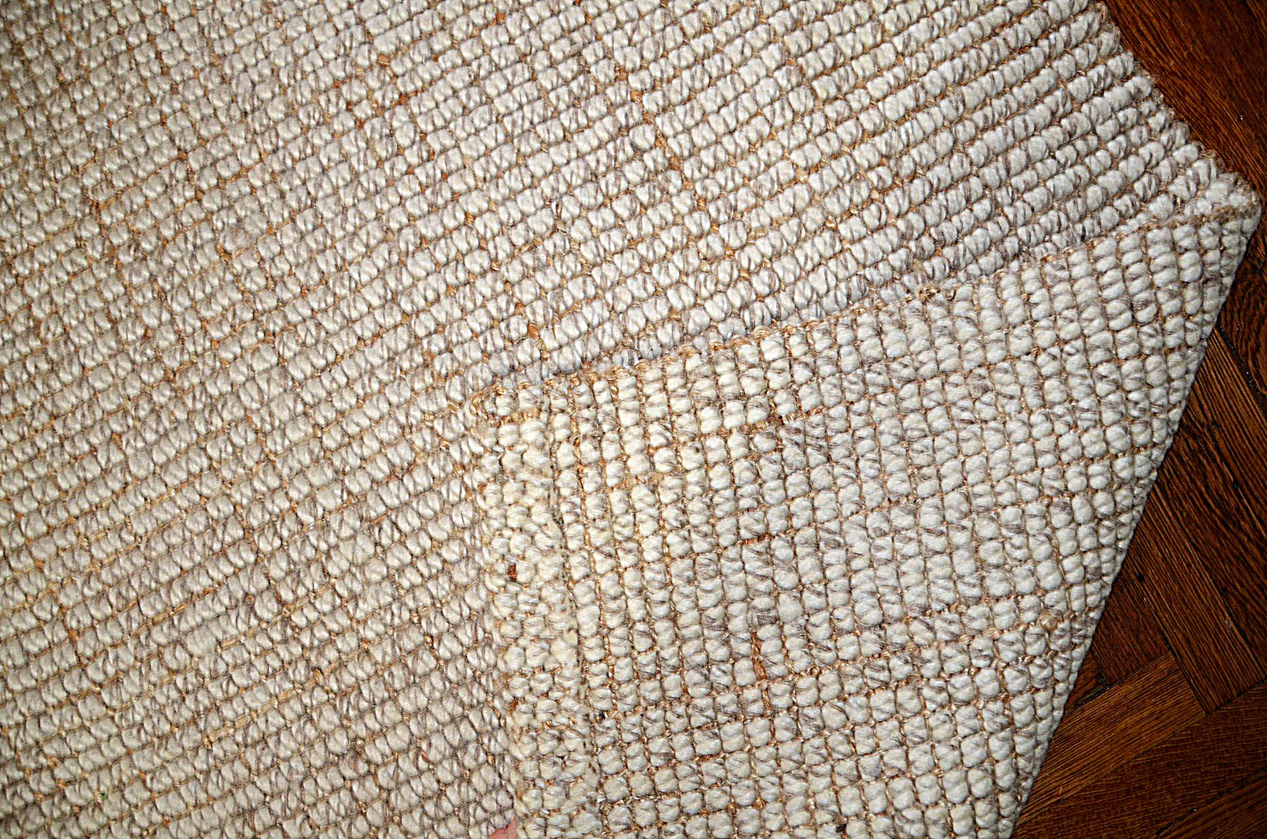 Neutral wool area rug.