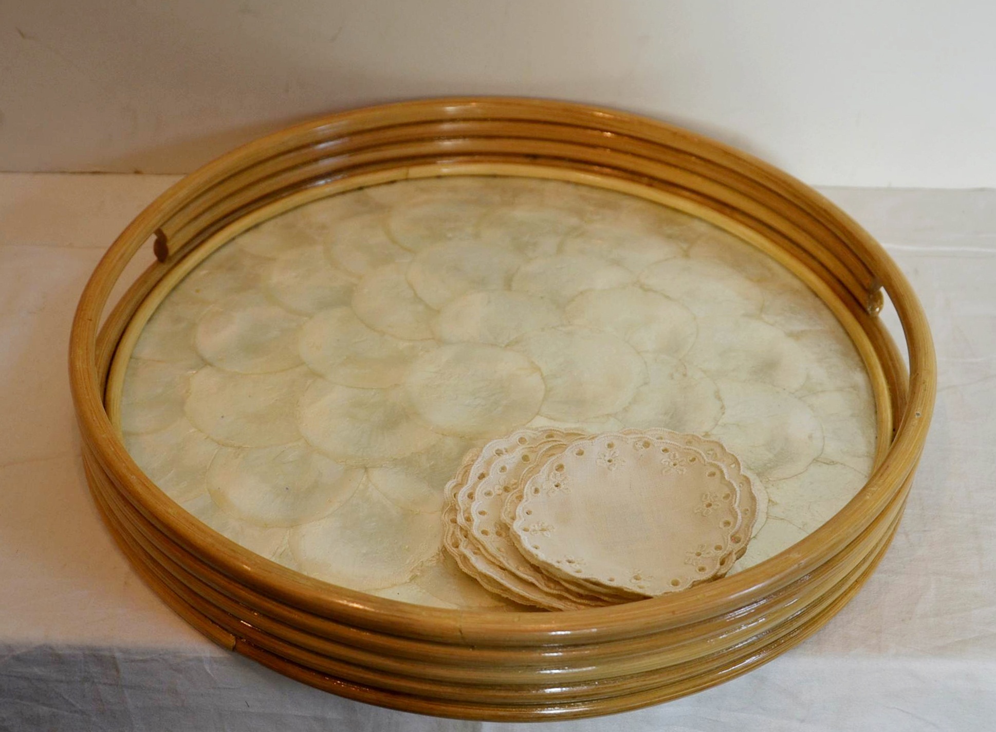 Oyster shell serving tray with stemware and coasters. 