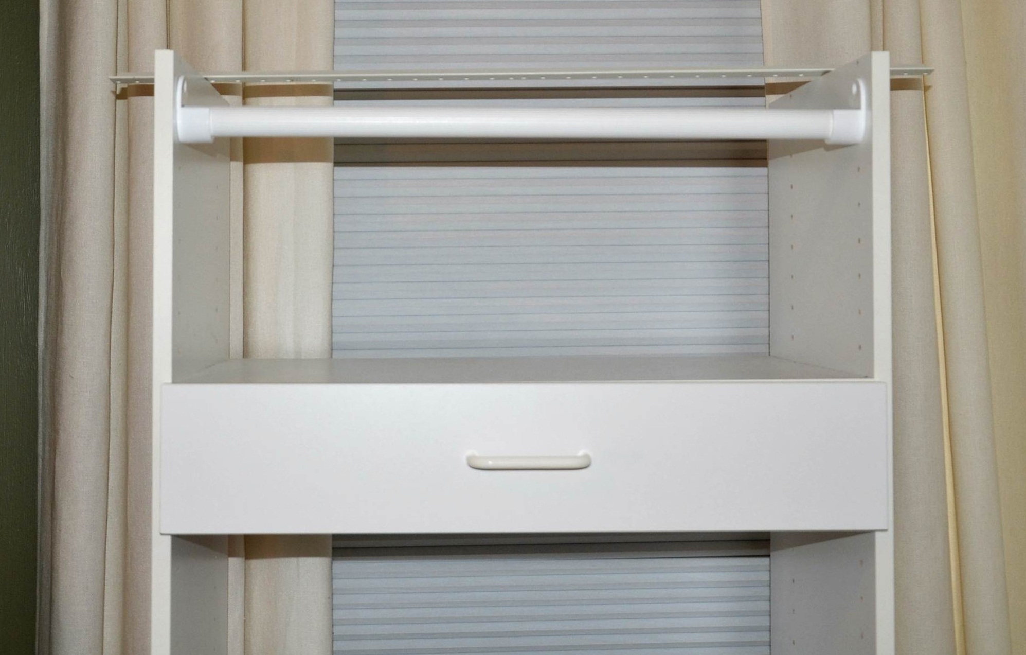 White laminate shelving unit.
