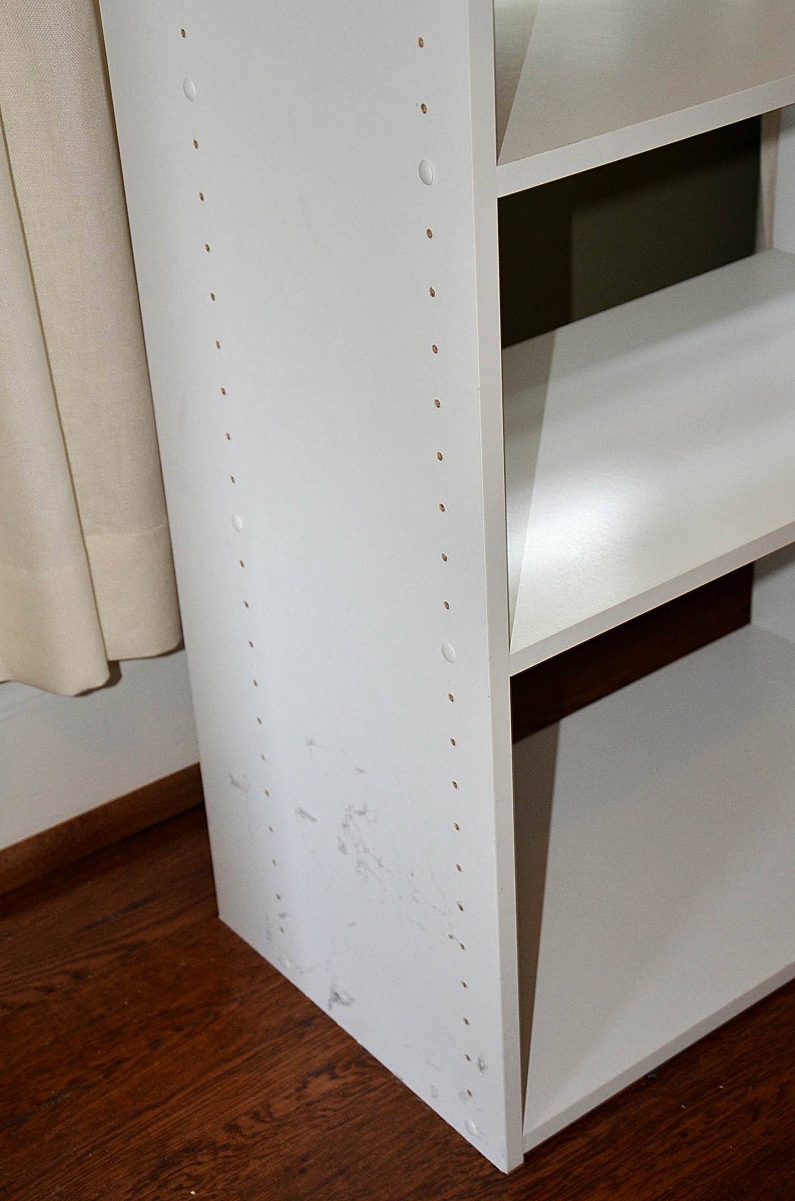 White laminate shelving unit.