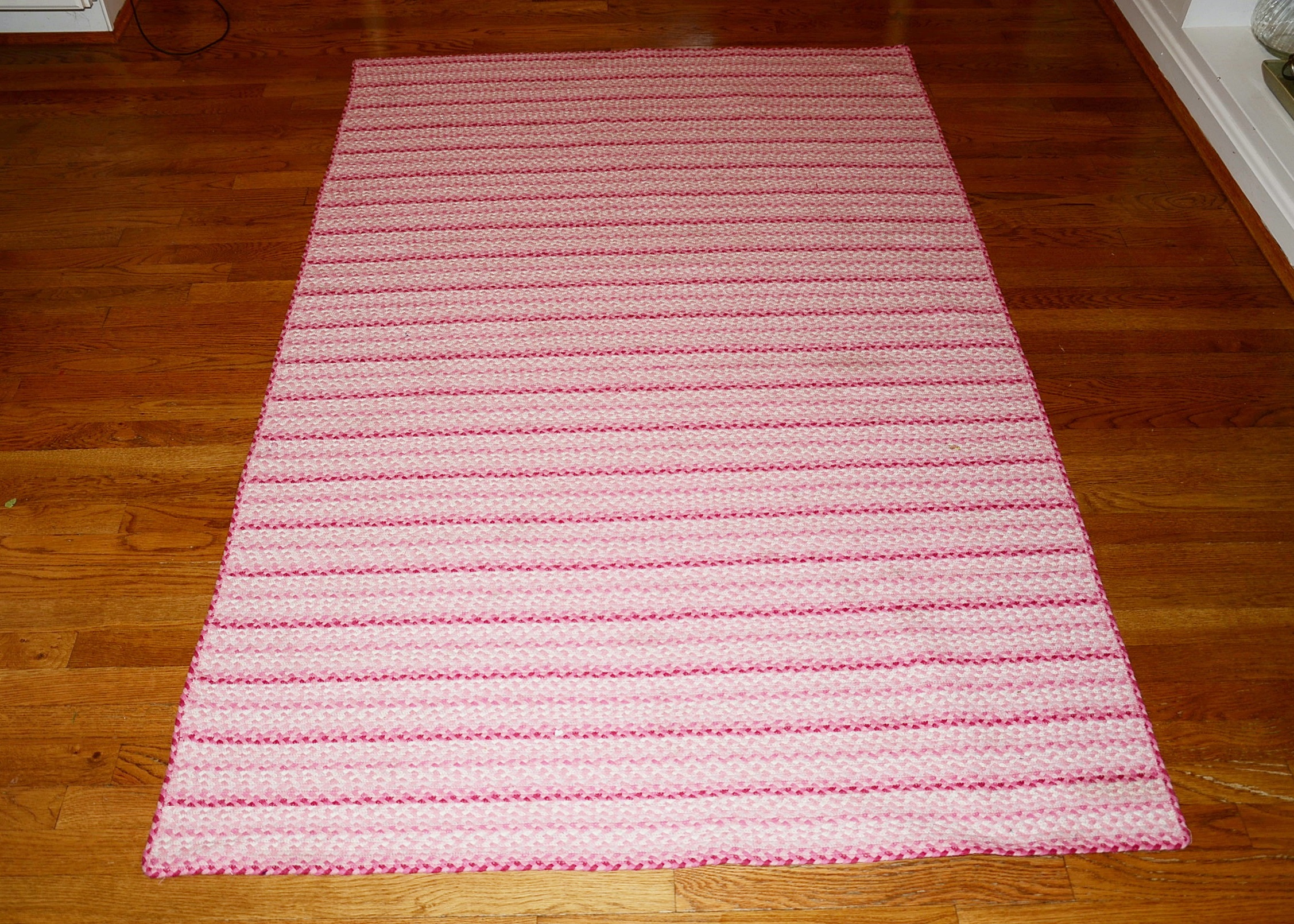 Machine made braided area rug.