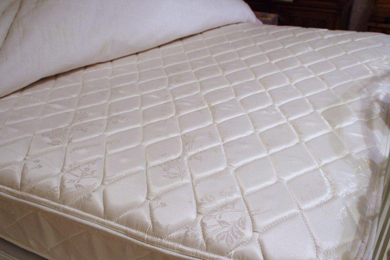Victorian Style Cast Iron Bed, with white painted finish and white lace comforter set
