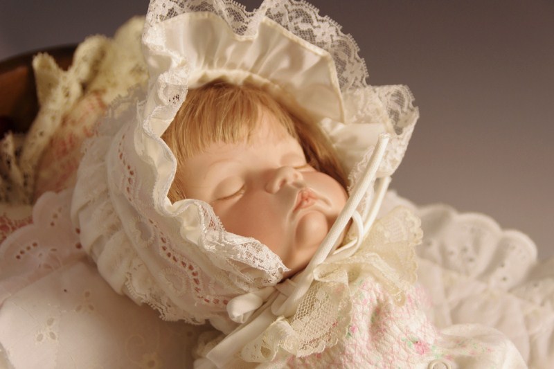 Vintage wooden doll cradle, with 'Sugar Britches' reproduction baby doll