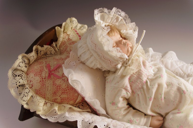 Vintage wooden doll cradle, with 'Sugar Britches' reproduction baby doll