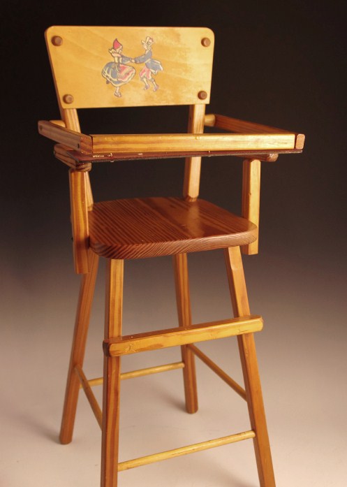 Vintage wooden high chair and rag doll with pin stripe dress