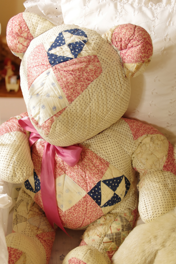 Cast Iron Crib, circa 1940-50, filled with Dolls, Bunnies, and Lace Pillows