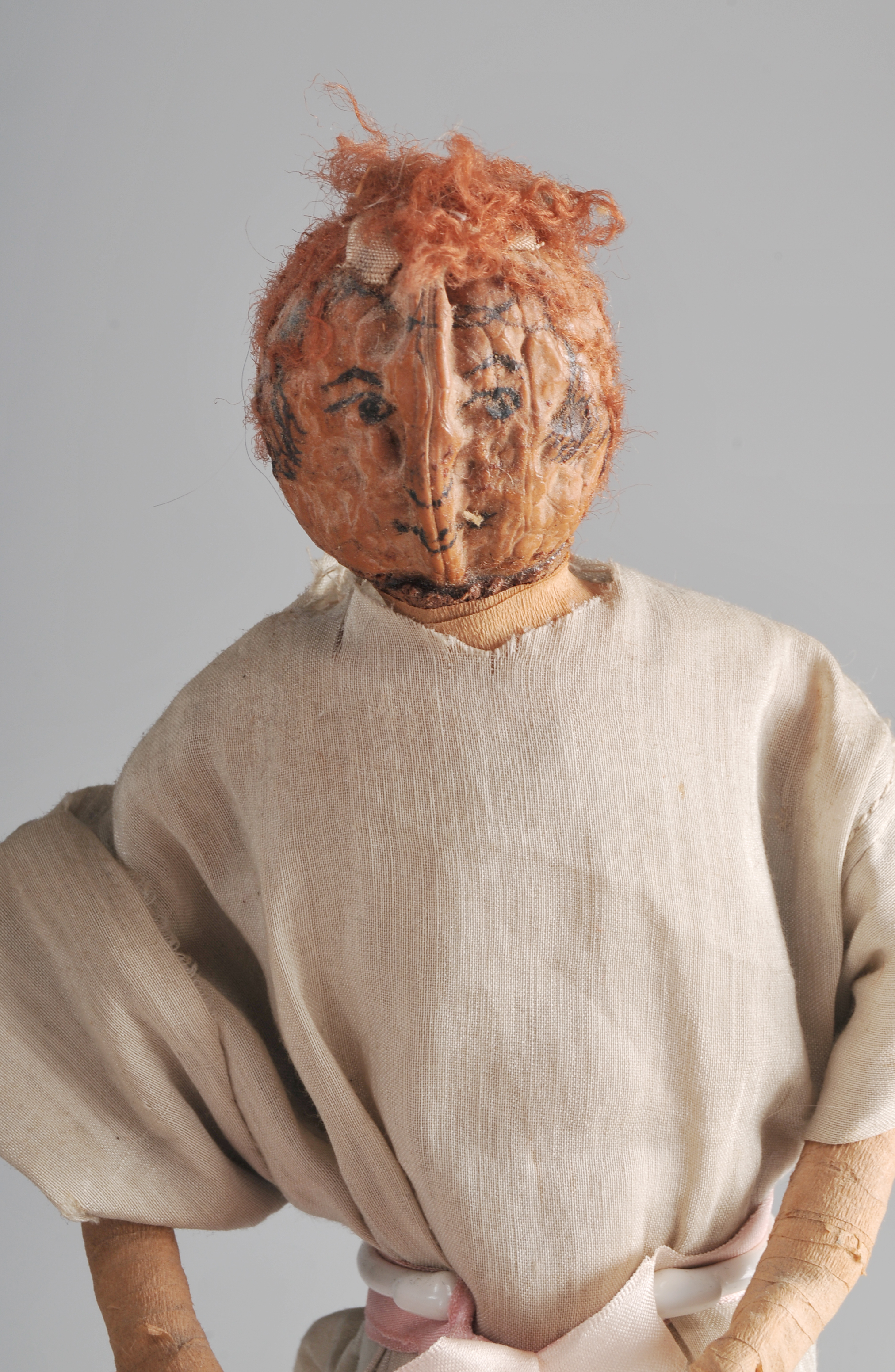 Folk Art Peach Pit Figurine