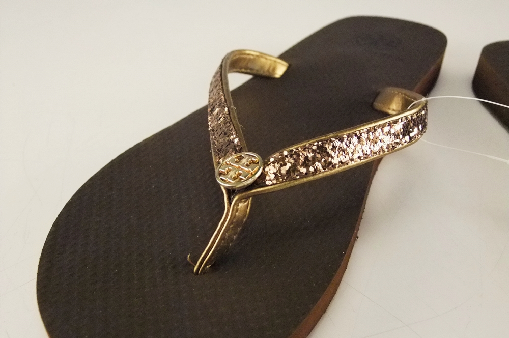 Pair of Tory Burch Bronze Adia Glitter Flip Flops