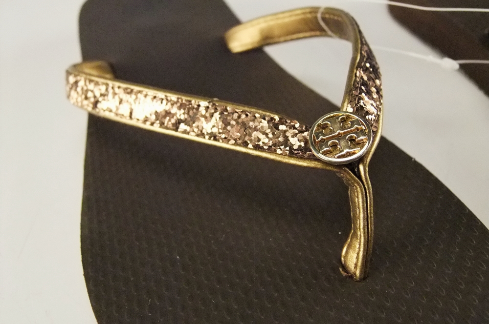 Pair of Tory Burch Bronze Adia Glitter Flip Flops