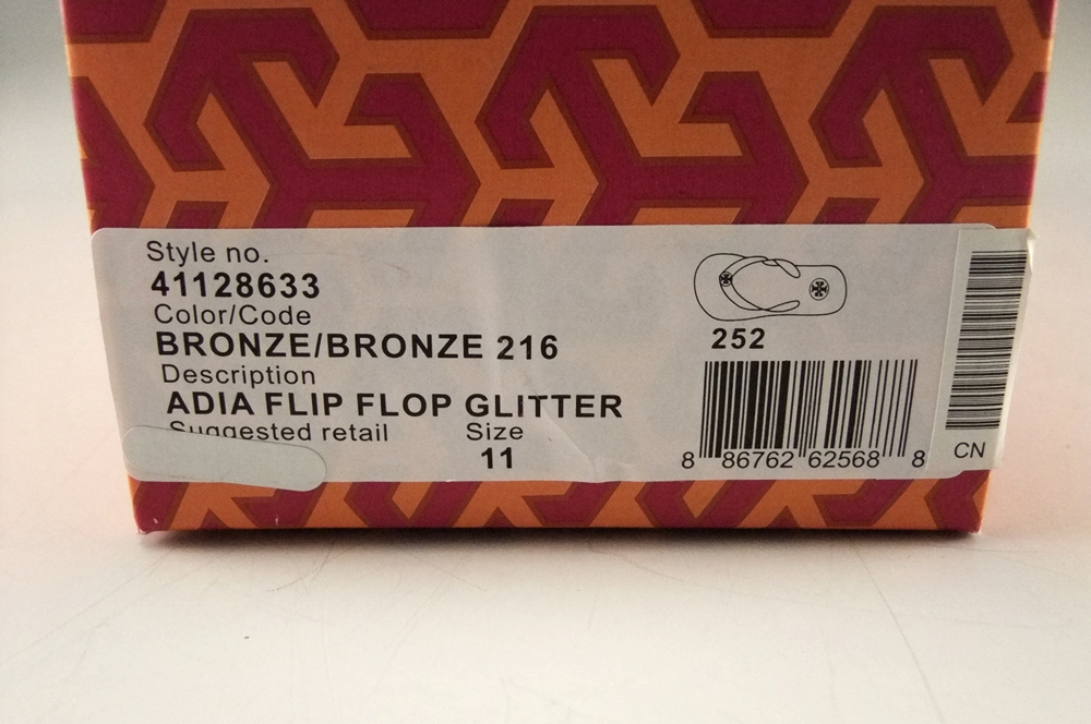 Pair of Tory Burch Bronze Adia Glitter Flip Flops