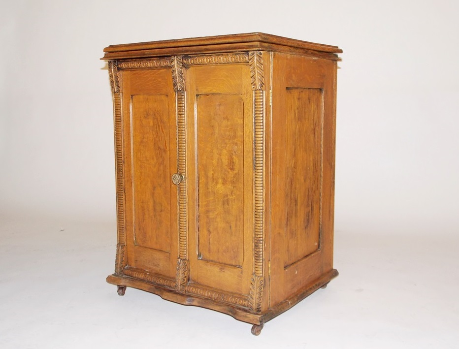 An Antique Minnesota Model B Treadle Sewing Machine in a Tiger oak Cabinet