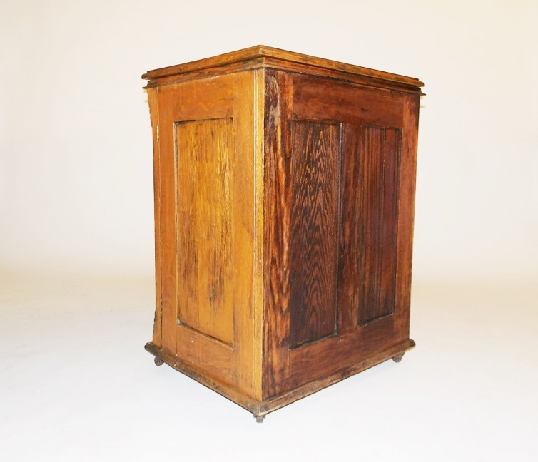 An Antique Minnesota Model B Treadle Sewing Machine in a Tiger oak Cabinet