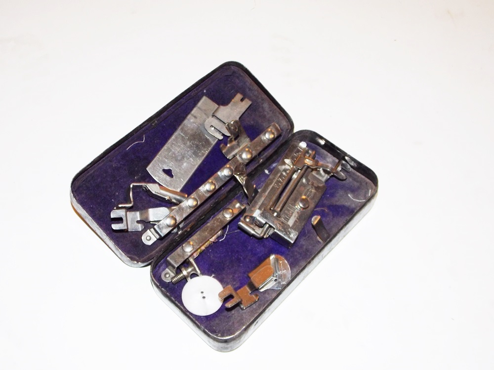 An Antique Minnesota Model B Treadle Sewing Machine in a Tiger oak Cabinet