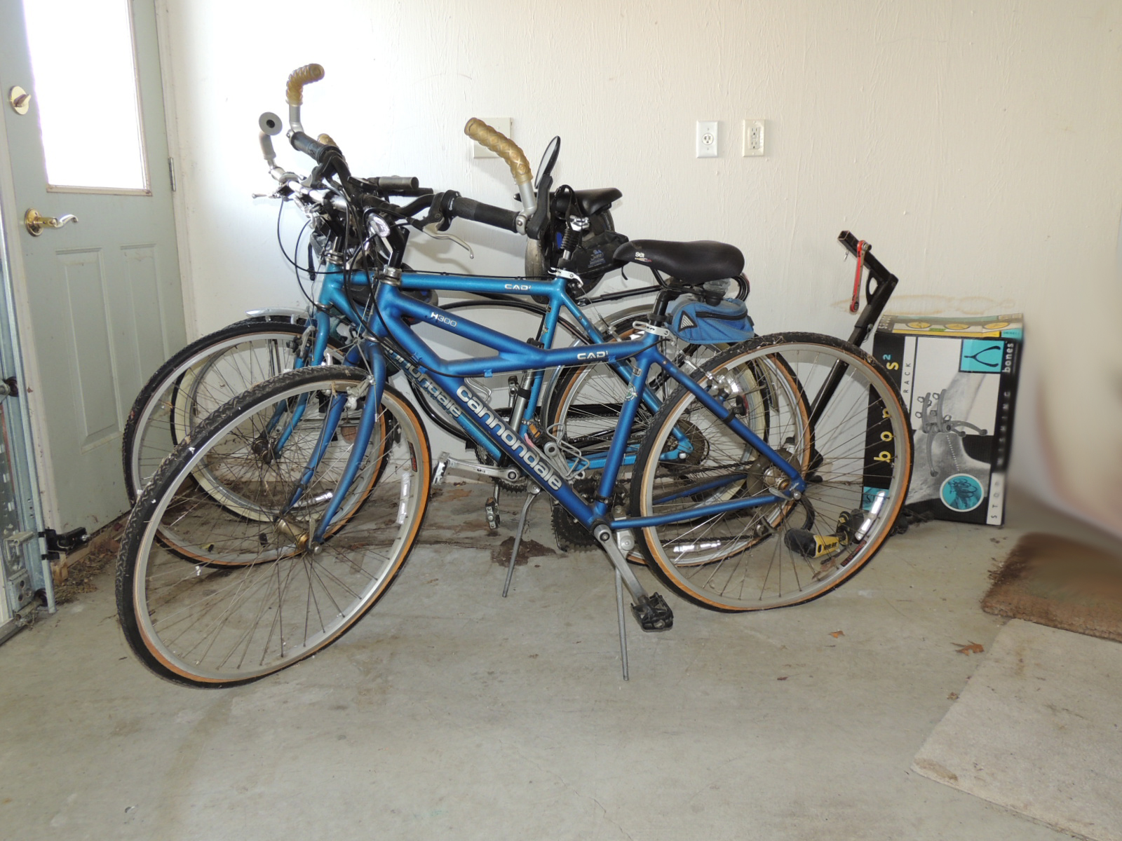 Two Cannondale Bicycles, a Schwinn Bicycle and Two Bike Racks