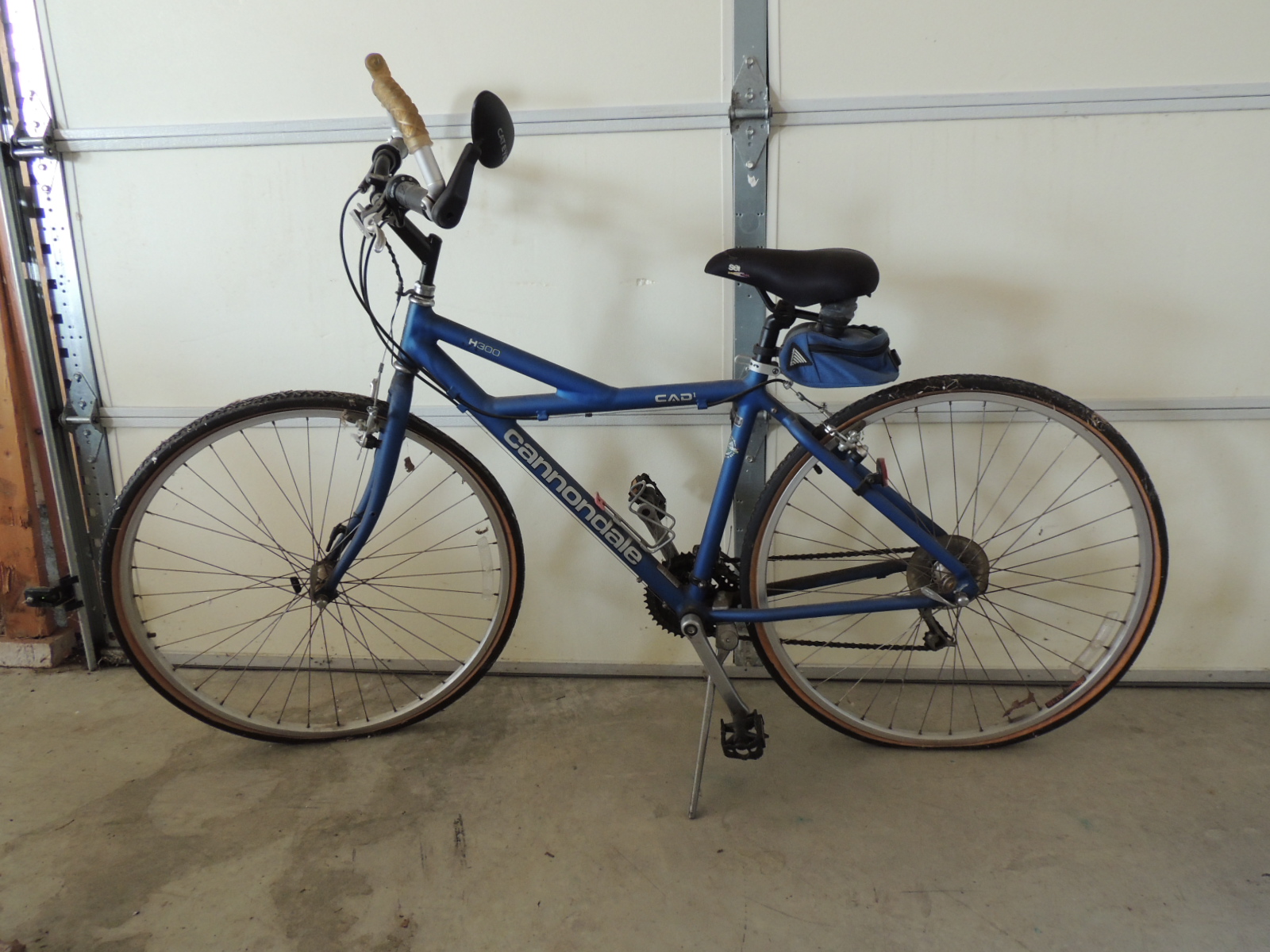 Two Cannondale Bicycles, a Schwinn Bicycle and Two Bike Racks