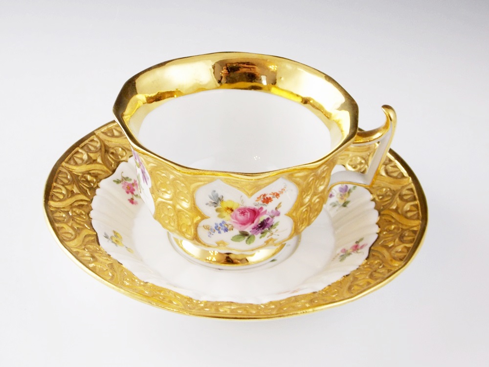 An Antique Meissen Tea Cup and Saucer in a Floral and Gold Pattern