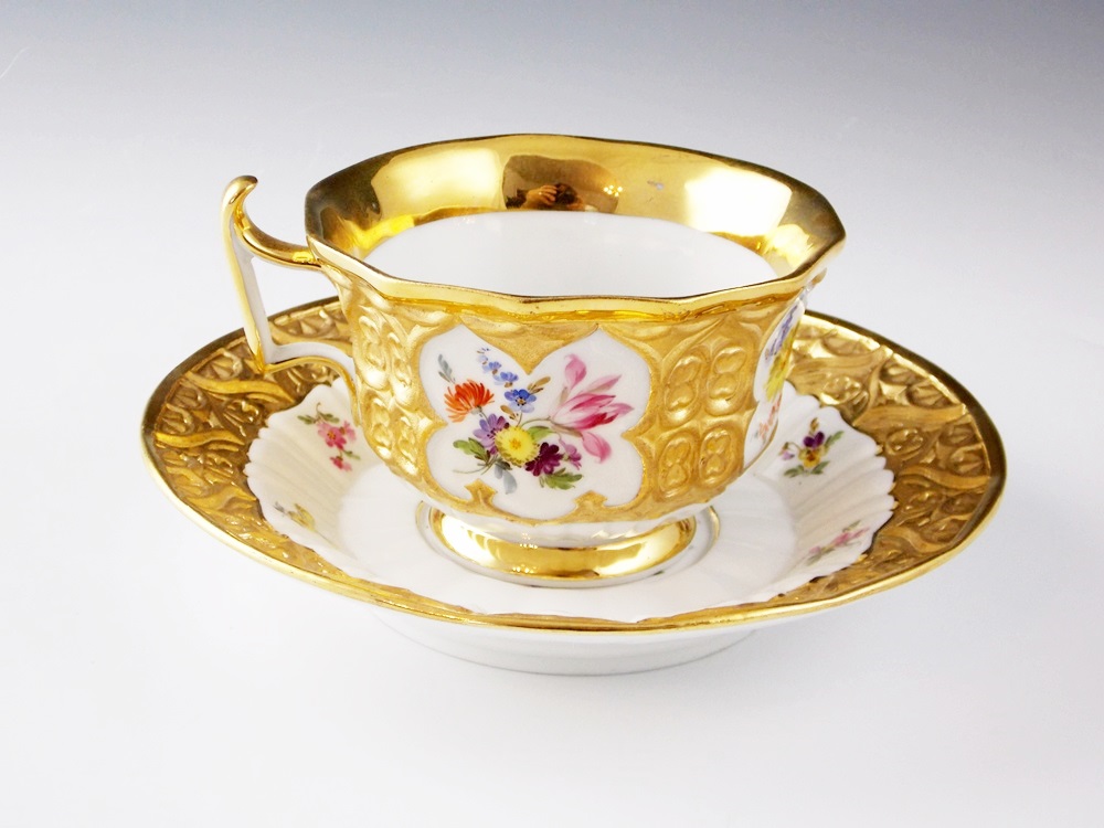 An Antique Meissen Tea Cup and Saucer in a Floral and Gold Pattern