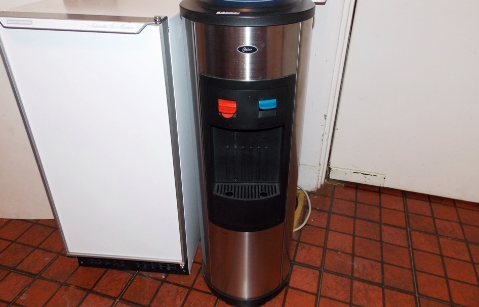 An Oster Hot and Cold Water Dispenser and A Scotsman Automatic Ice Machine