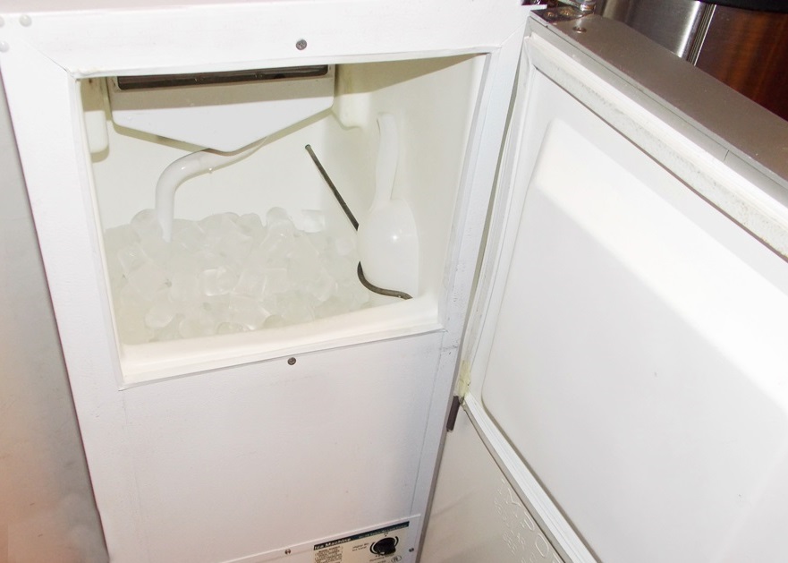 An Oster Hot and Cold Water Dispenser and A Scotsman Automatic Ice Machine