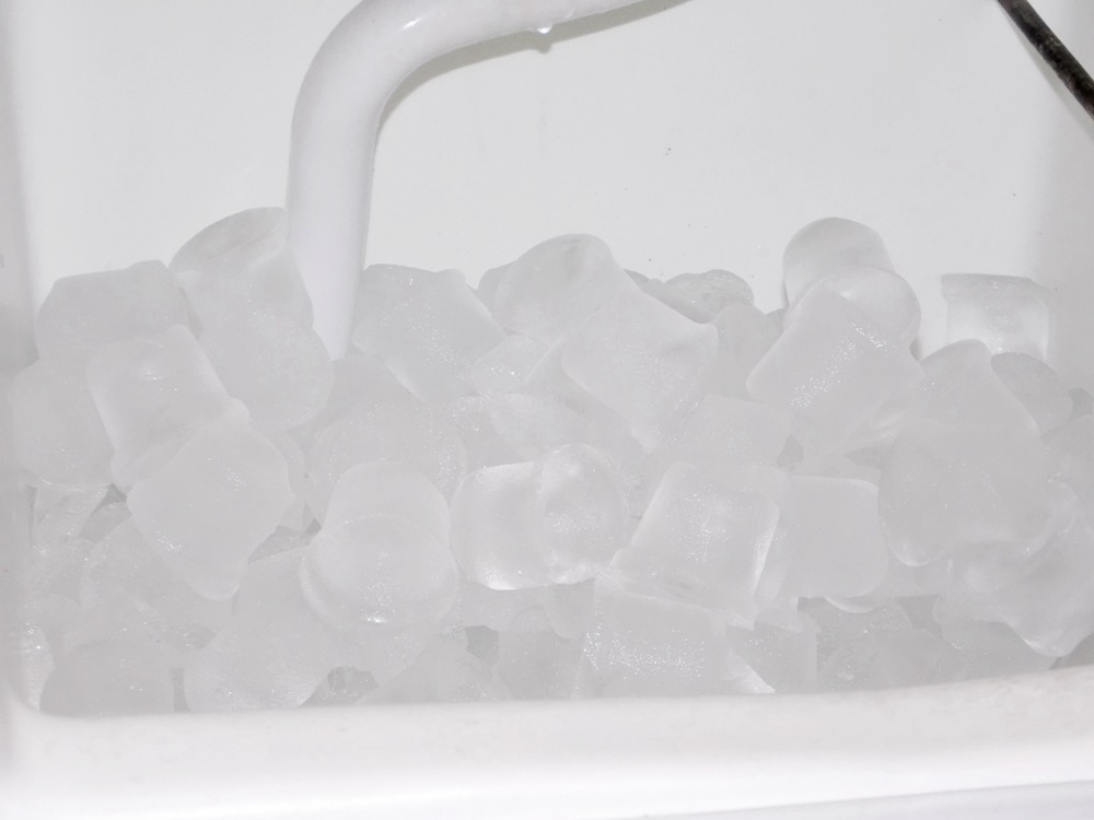 An Oster Hot and Cold Water Dispenser and A Scotsman Automatic Ice Machine