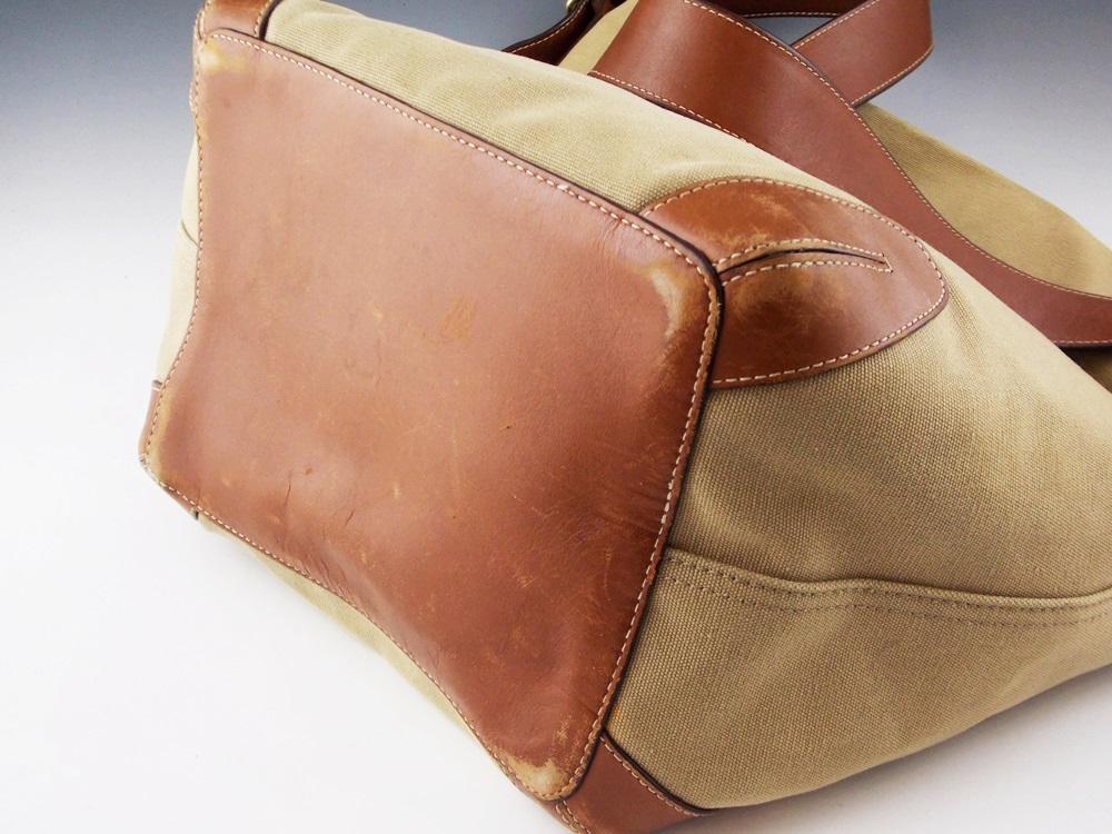 A Coach Bucket Style Handbag in tan twill with Leather Strap and Bottom