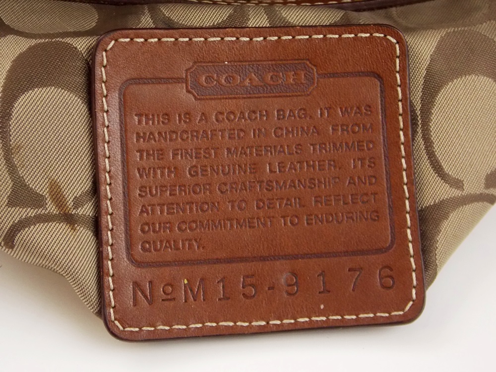 A Coach Bucket Style Handbag in tan twill with Leather Strap and Bottom