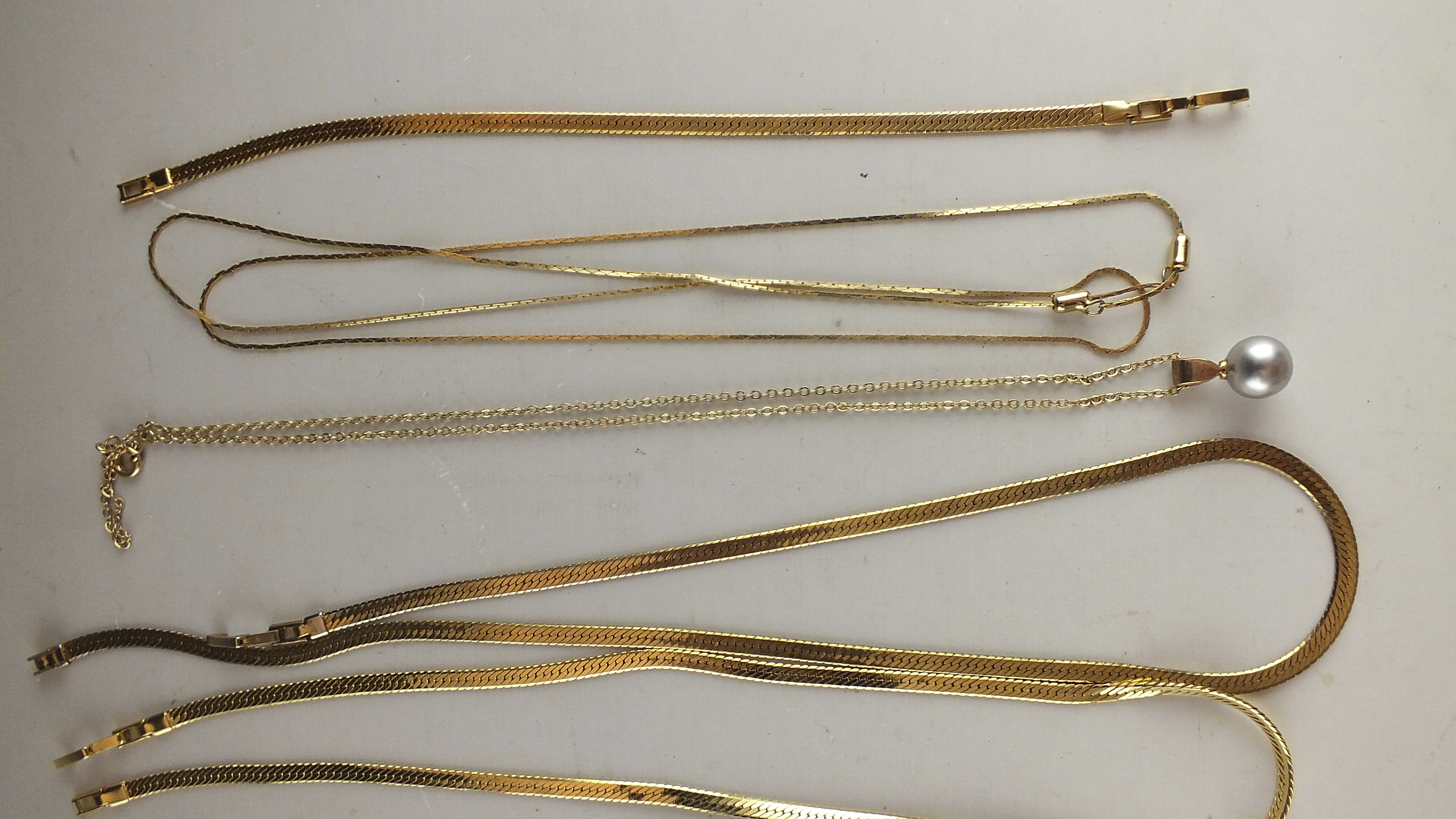 Eight Assorted  Gold Toned Necklaces 
