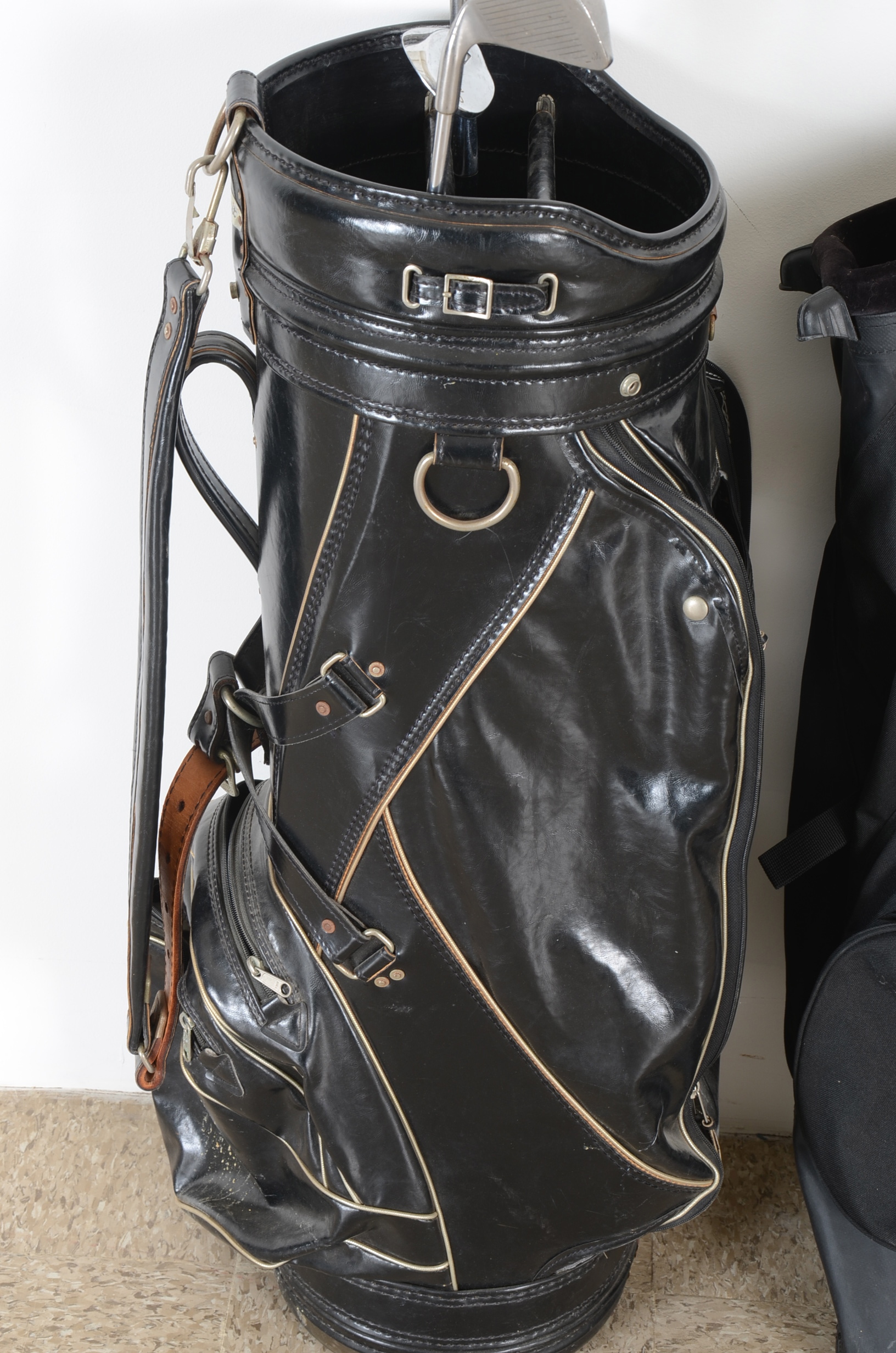 Three Golf Bags and Four Clubs