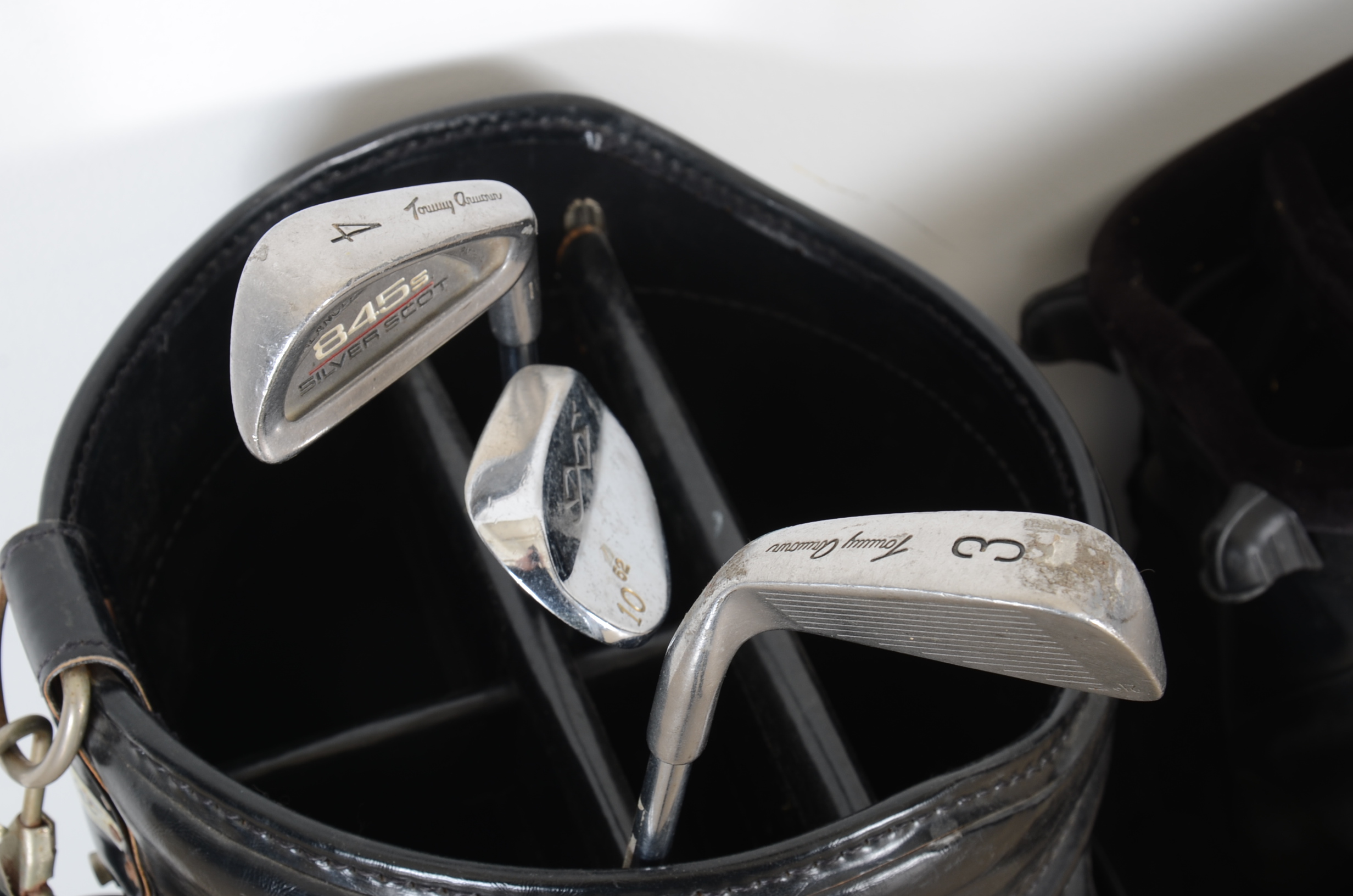 Three Golf Bags and Four Clubs