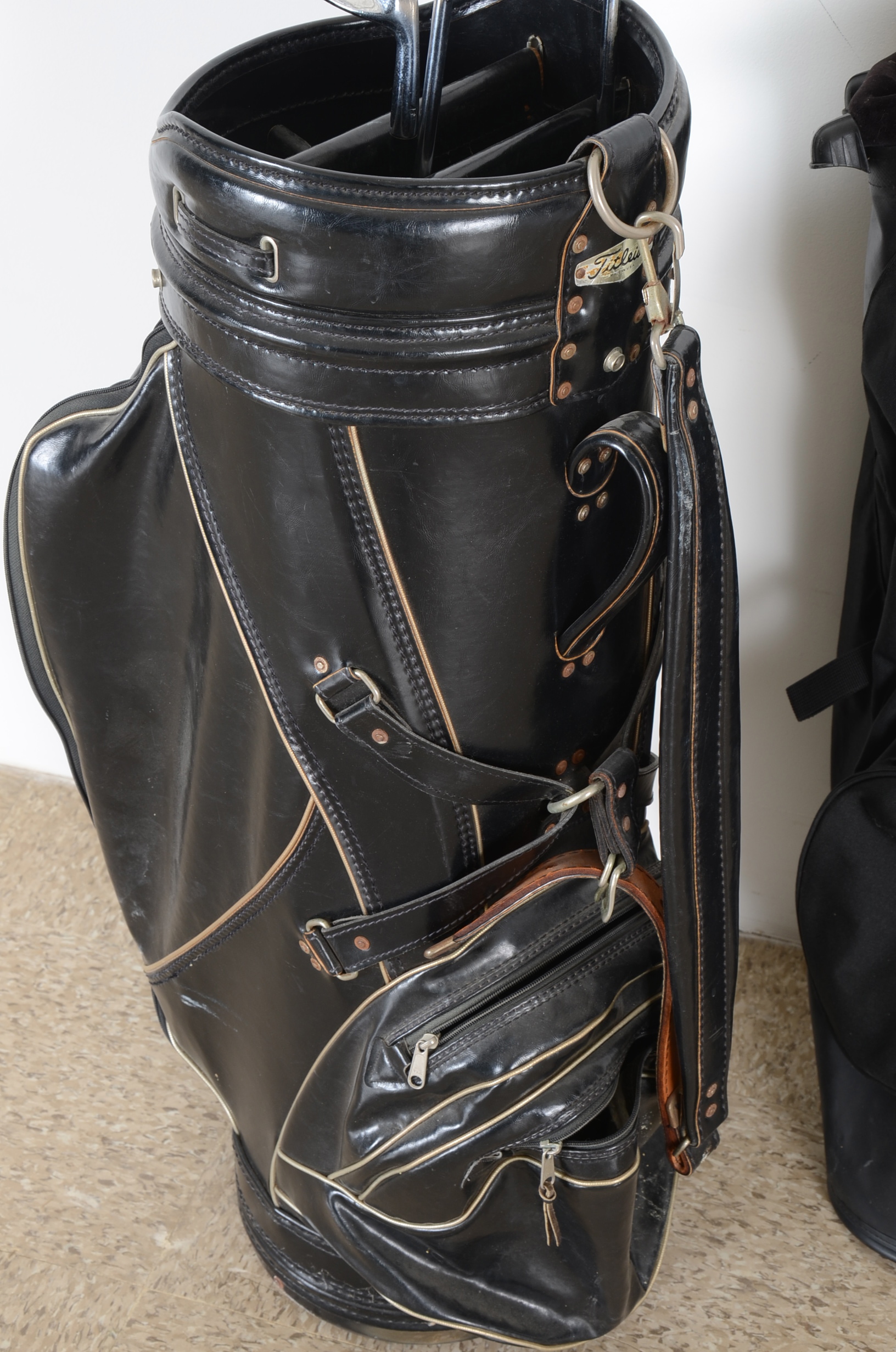 Three Golf Bags and Four Clubs